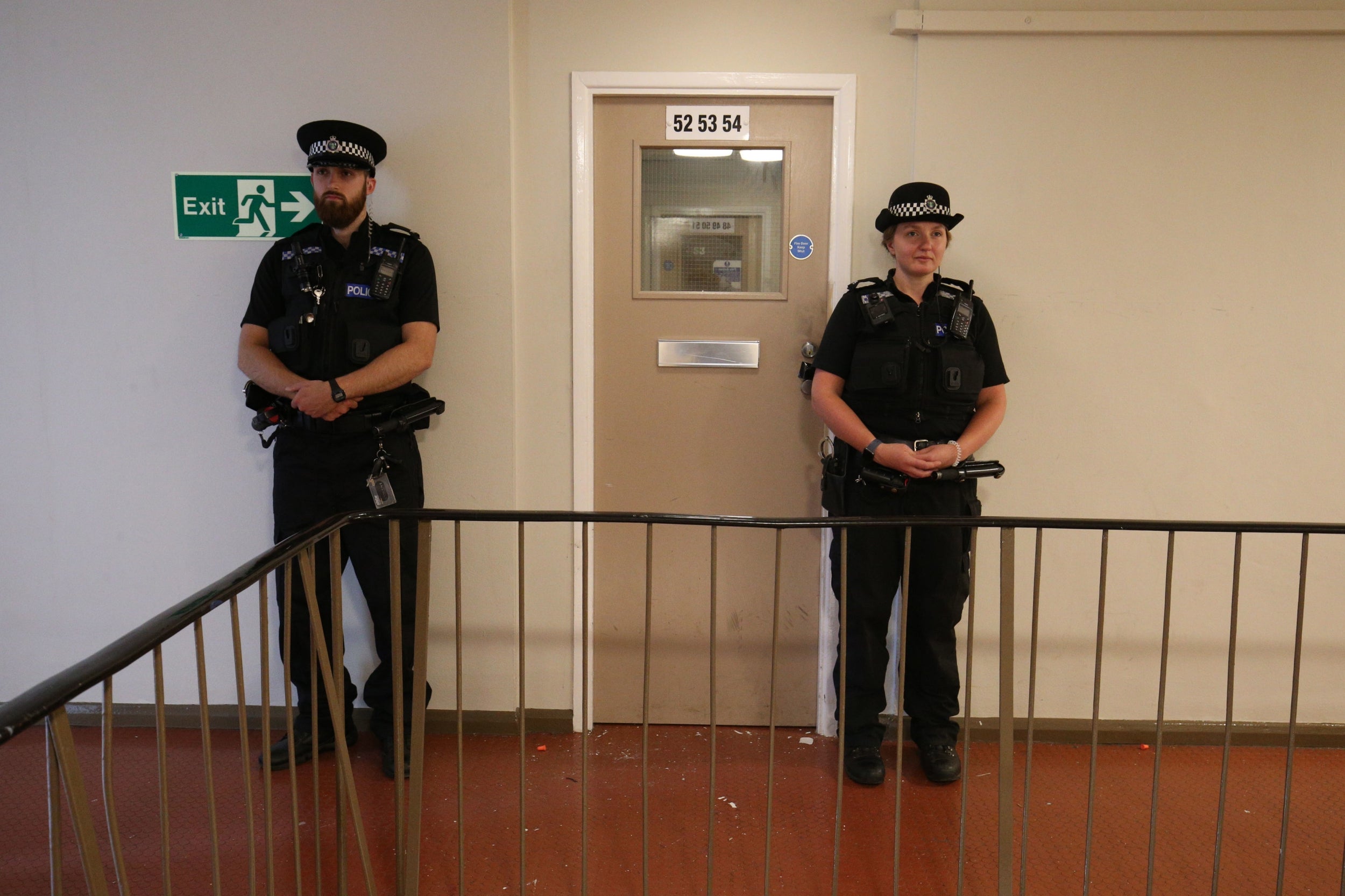 Police officers standing guard outside the corridor of a top-floor flat in Basingstoke Road, Reading, where the suspect in the Forbury Gardens stabbings was detained. The suspect in the Reading stabbings is a Libyan asylum seeker and mental health is being considered a major factor in the incident, a security source has told the PA news agency. PA Photo. Picture date: Sunday June 21, 2020.