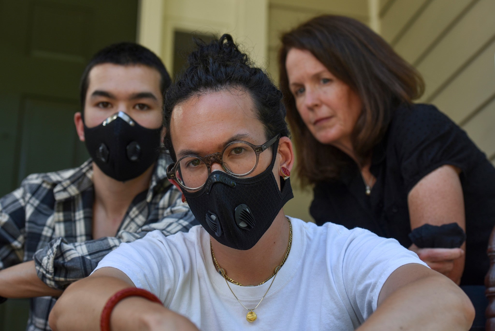 Charlie Mai (centre) and Henry Mai (left) pose with their mother, Mary, at their home in Arlington, Virginia. Their father threatened to leave during an argument over the George Floyd protests