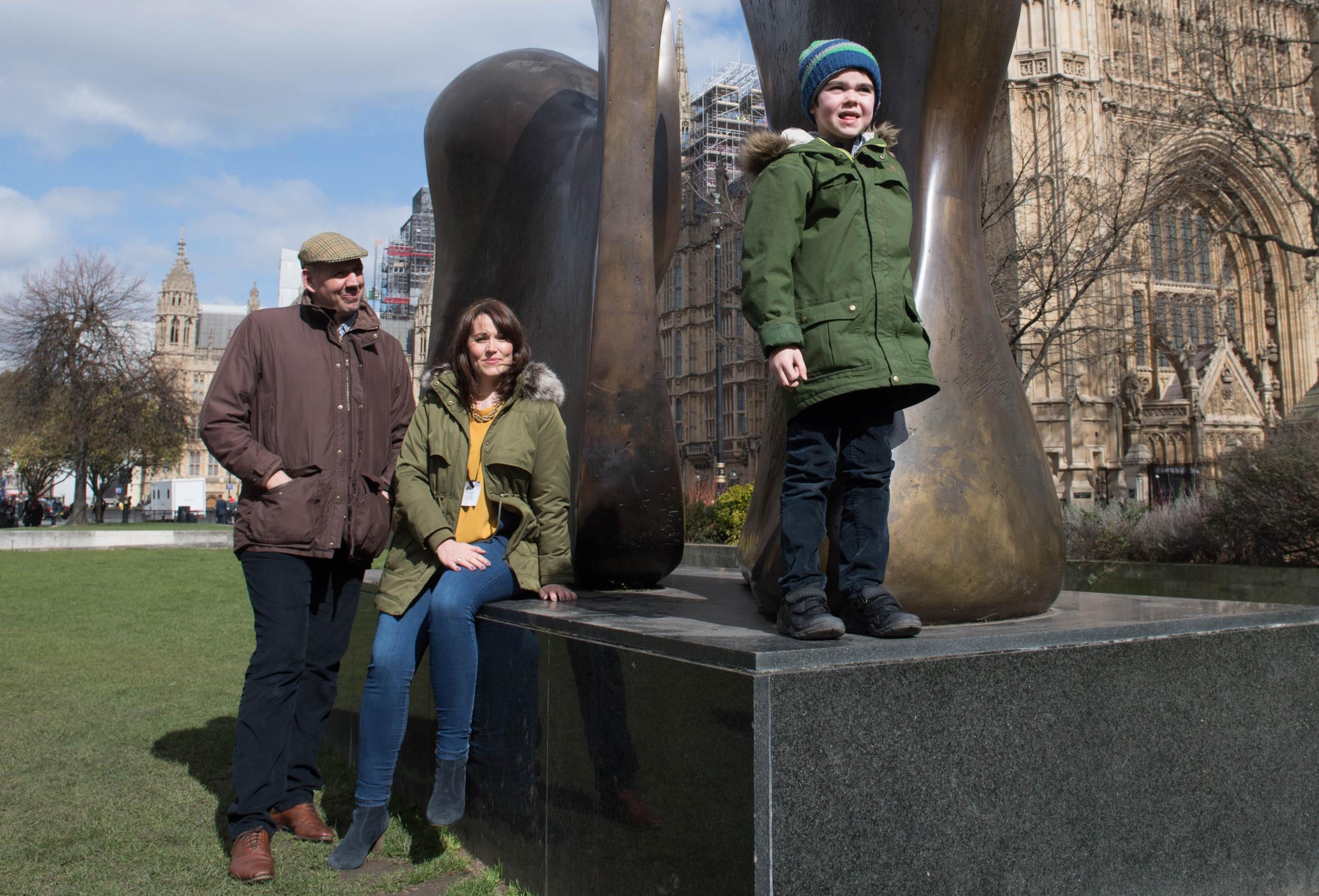 Alfie Dingley with his parents Drew Dingley and Hannah Deacon in Westminster, London. Picture by Stefan Rousseau, PA