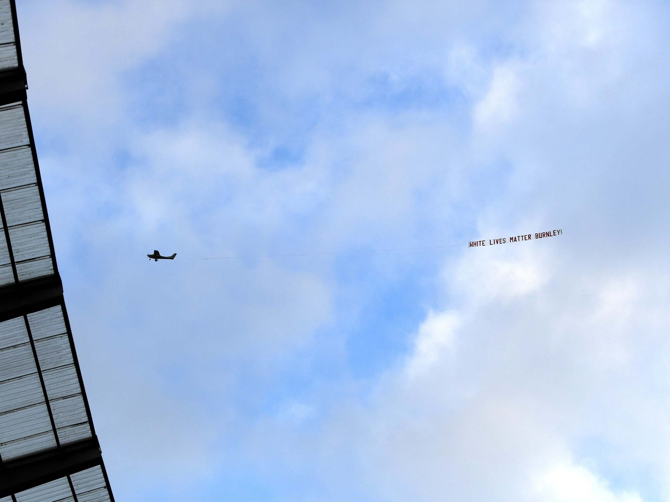 ‘White Lives Matter – Burnley’ banner is pictured flying over the Etihad