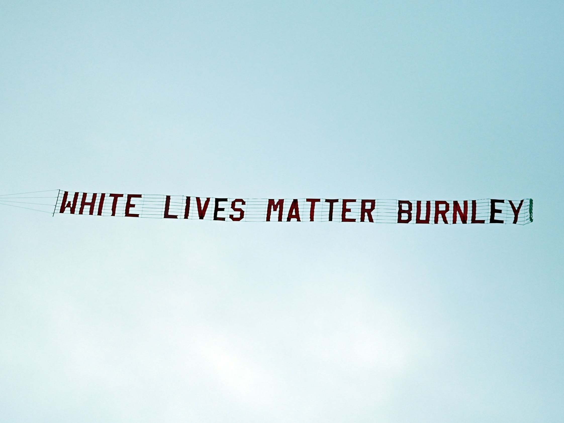A message reading 'White Lives Matter Burnley' is flown over the Etihad Stadium