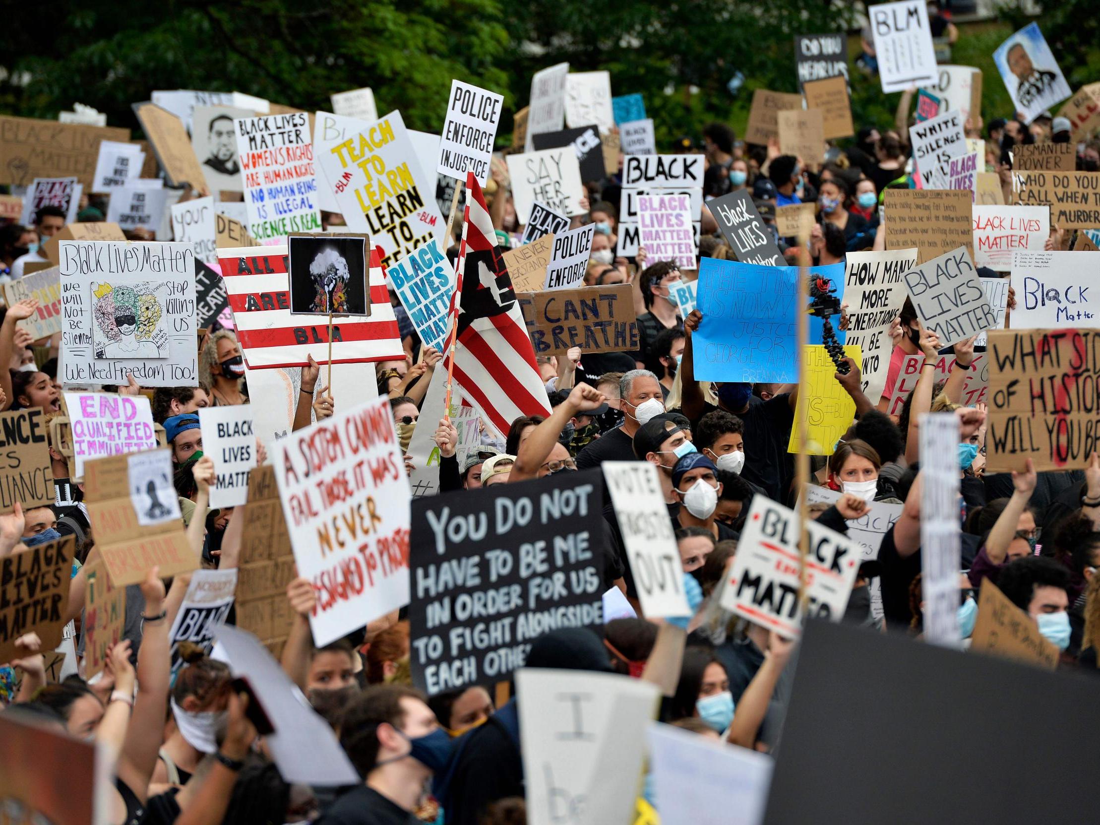 Protesters rally on the steps of the State House in Rhode Island calling for an end to Police injustice