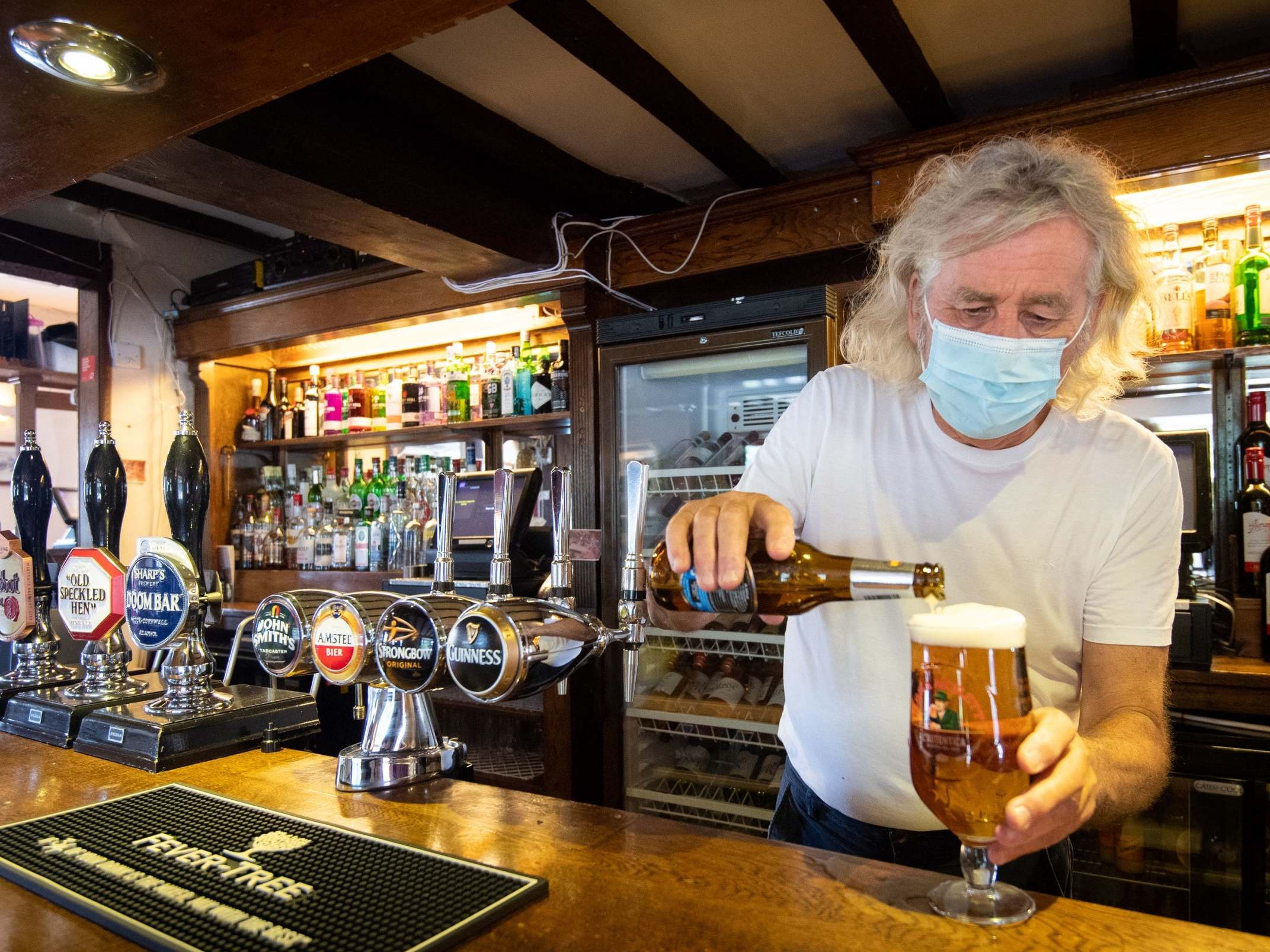 Phil Weaver, owner of The Old Smith in Church Lawford, Warwickshire, pours a drink as pub and hospitality bosses have cheered the government’s proposals to allow customers through their doors again