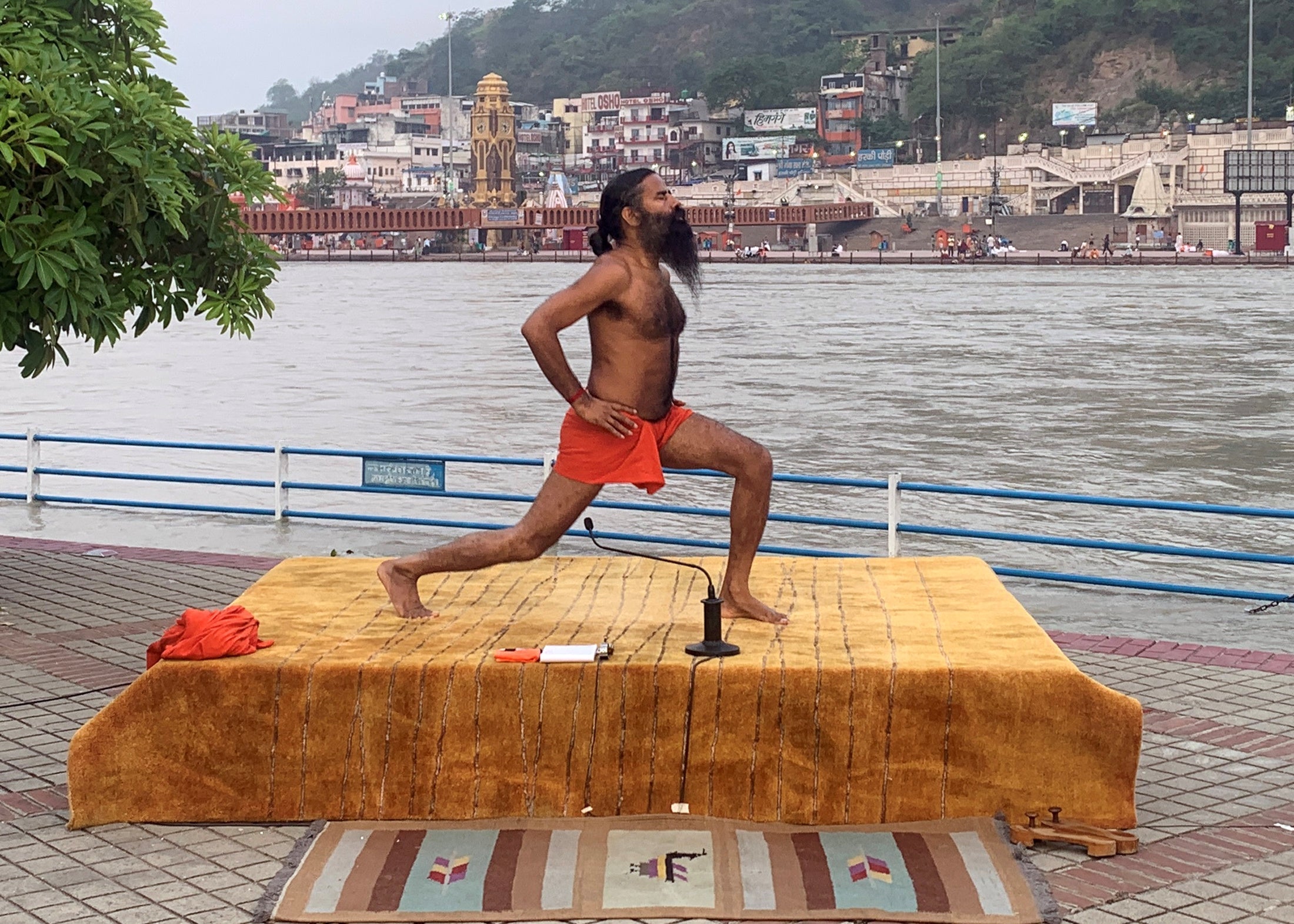 India's yoga guru Baba Ramdev performing yoga on the banks of the river Ganges ahead of International Yoga day, in the northern town of Haridwar, India, on 19 June