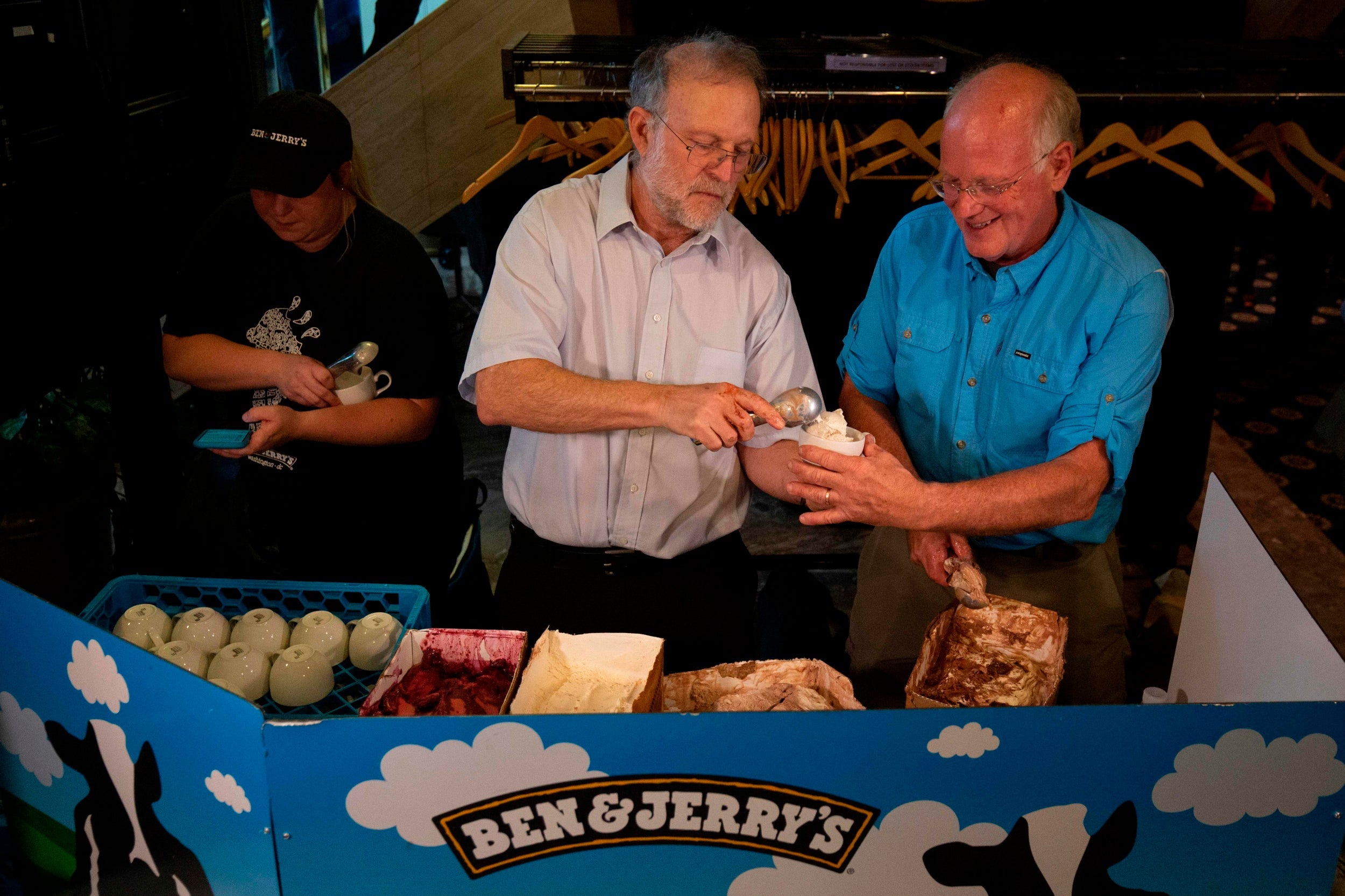 Ben and Jerry’s cofounders Ben Cohen (left) and Jerry Greenfield serve Justice ReMix’d. a flavour backing criminal justice reform, in 2019 (AFP)