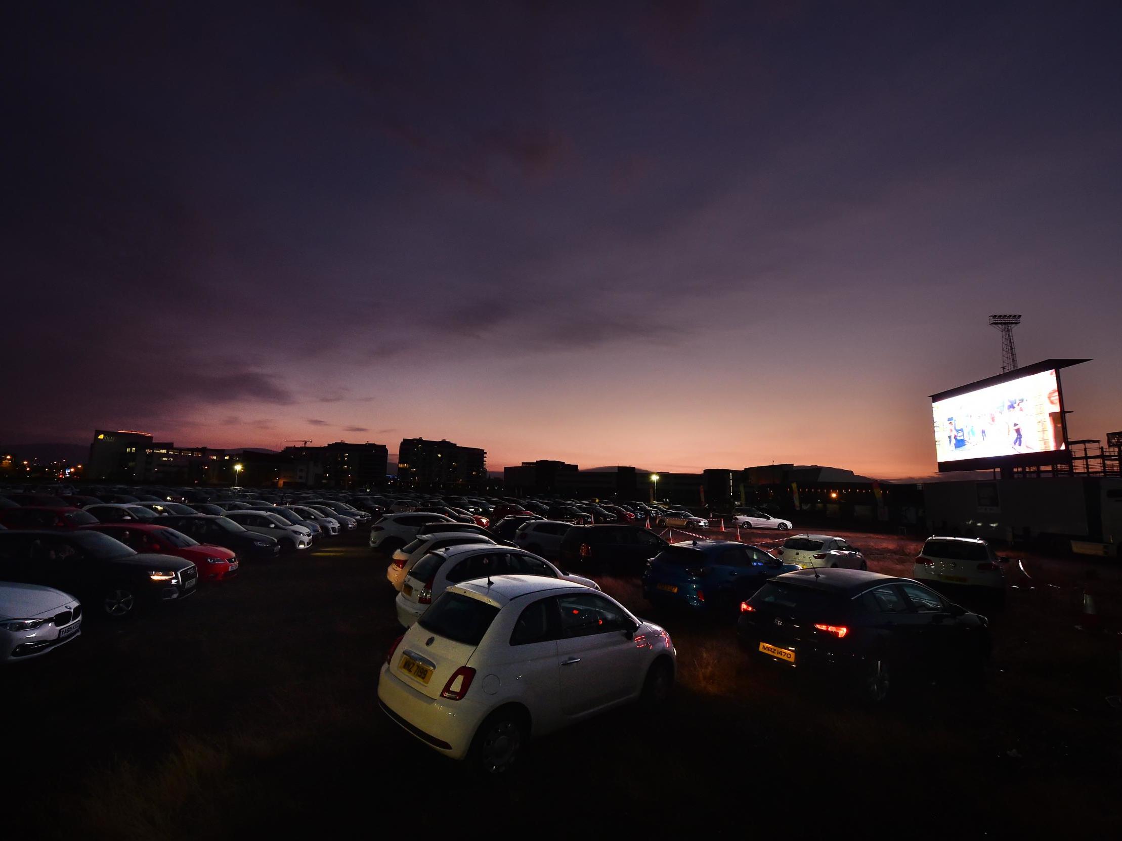 Movie-goers watch ‘Grease’ projected onto an outdoor screen in the Tantanic Quarter in Belfast, Northern Ireland