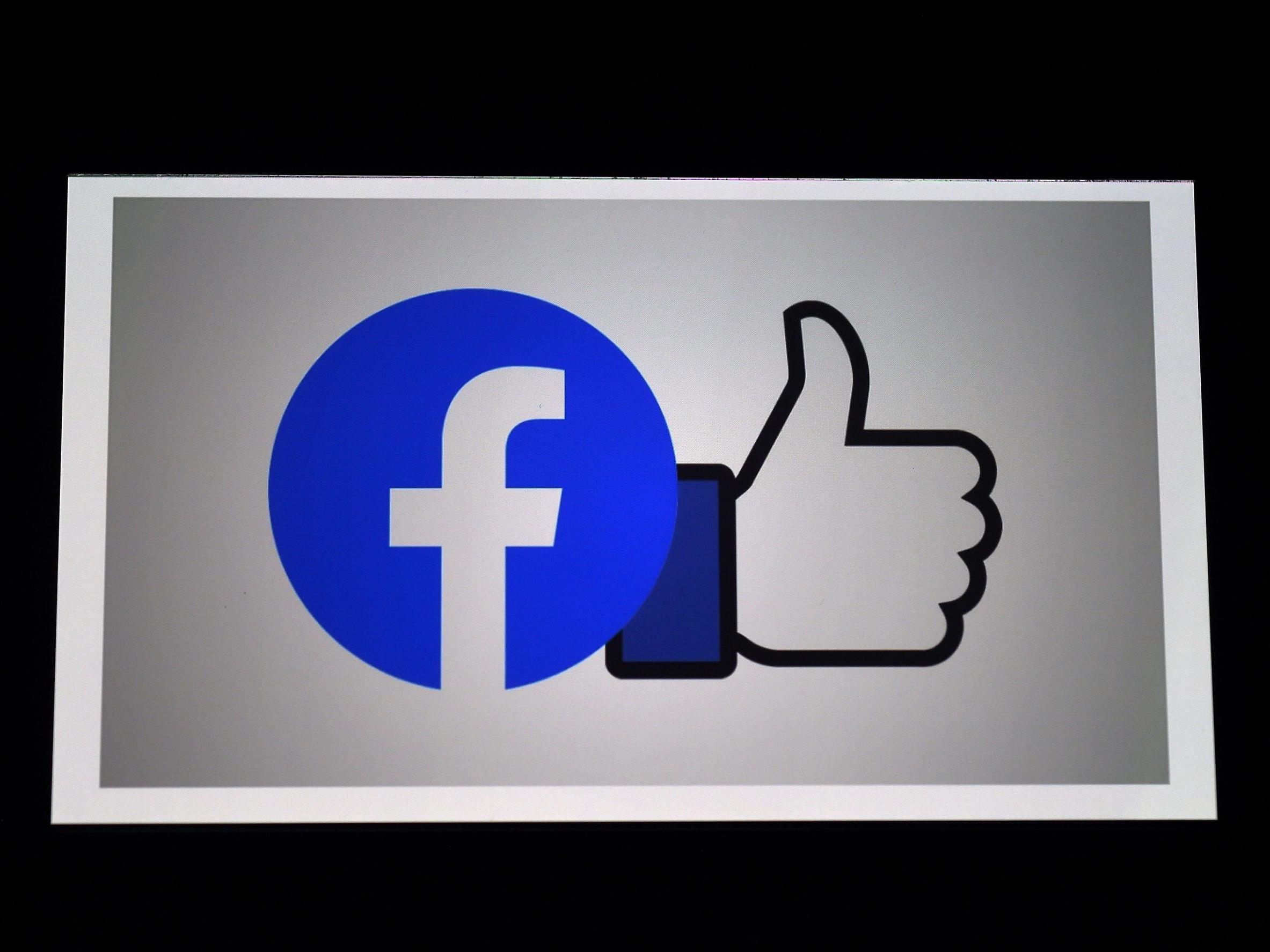 A Facebook App logo is displayed on a smartphone in Arlington, Virginia