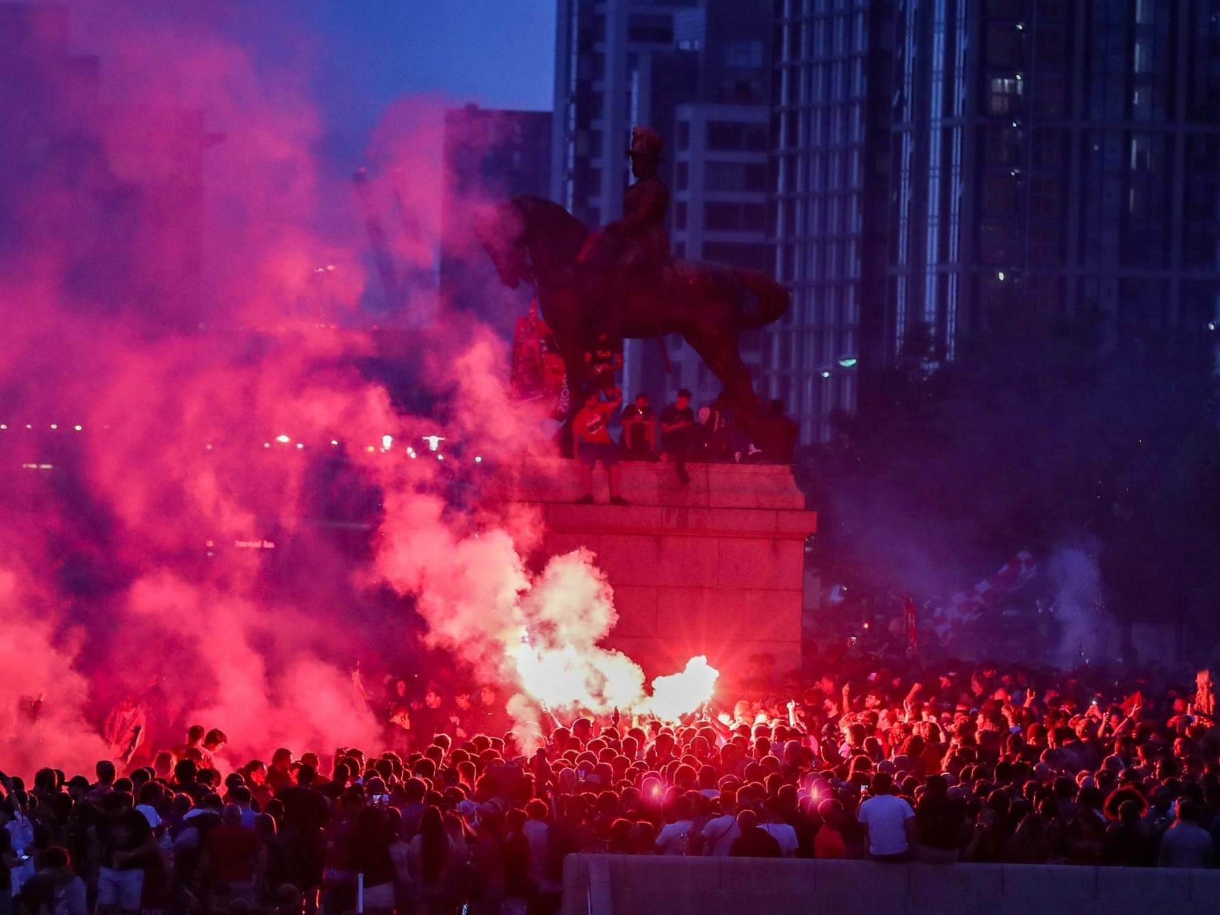 Liverpool fans let off flares outside the Liver Building in Liverpool