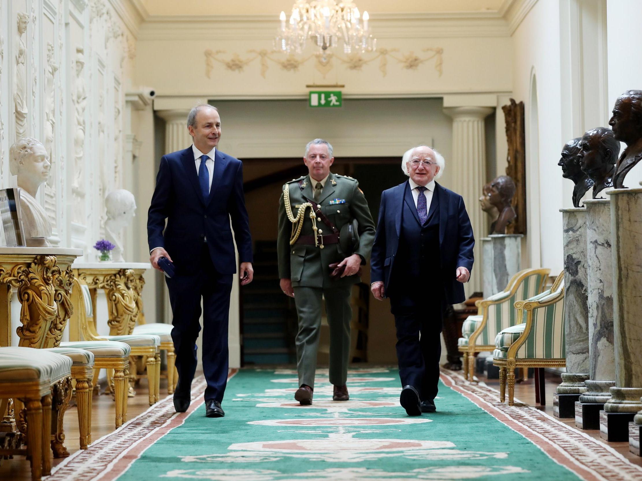 Ireland's new Taoiseach Micheal Martin (L) attends a meeting with Irish President Michael D. Higgins (R) to be formally appointed to his post at the Aras an Uachtarain presidential residence in Dublin, Ireland