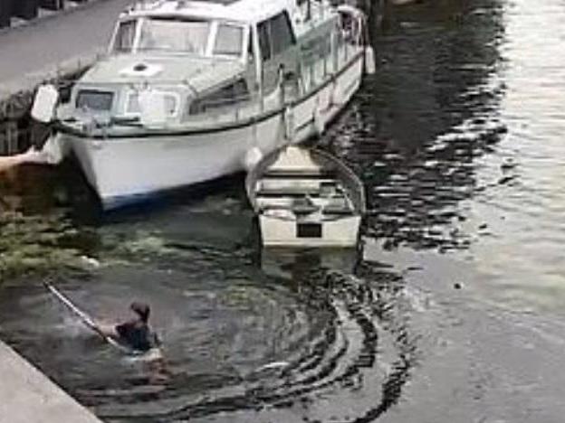 Intervening man in the canal after getting pushed in