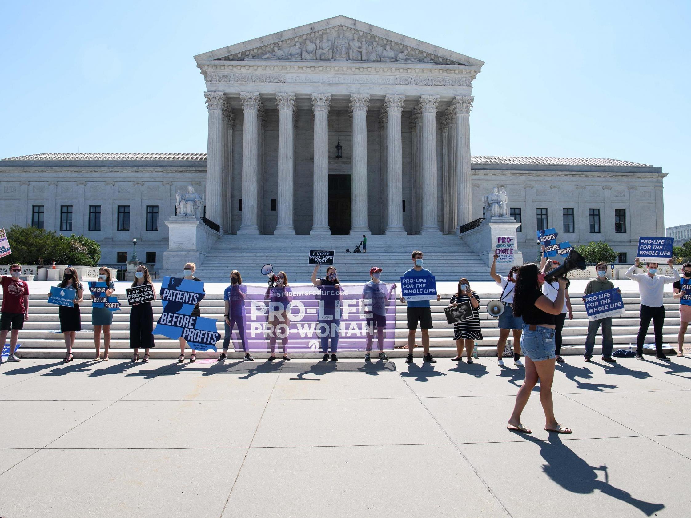 The Supreme Court blocked a Louisiana law that would require doctors to have admitting privileges at local hospitals. Advocates for the law gathered outside the Supreme Court on Monday (pictured)