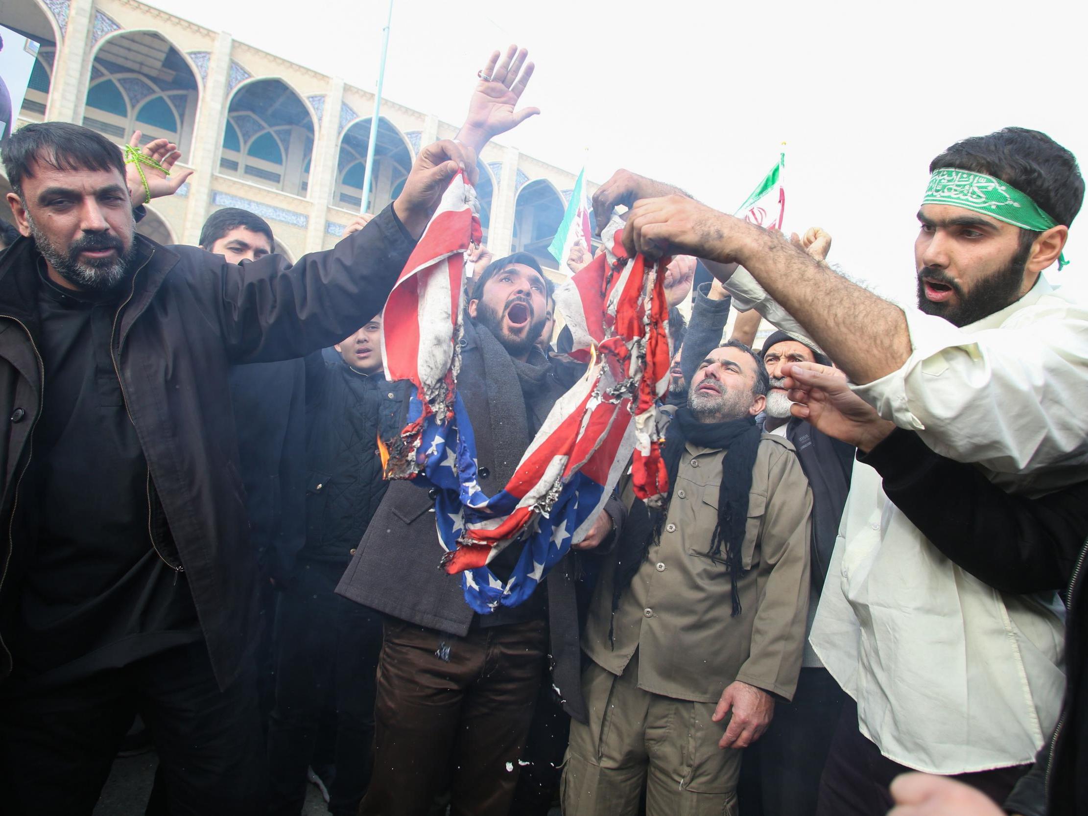 Iranians burn a US flag during a demonstration against American "crimes" in Tehran on 3 January, 2020 following the killing of Iranian Revolutionary Guards Major General Qasem Soleimani in a US strike on his convoy at Baghdad international airport