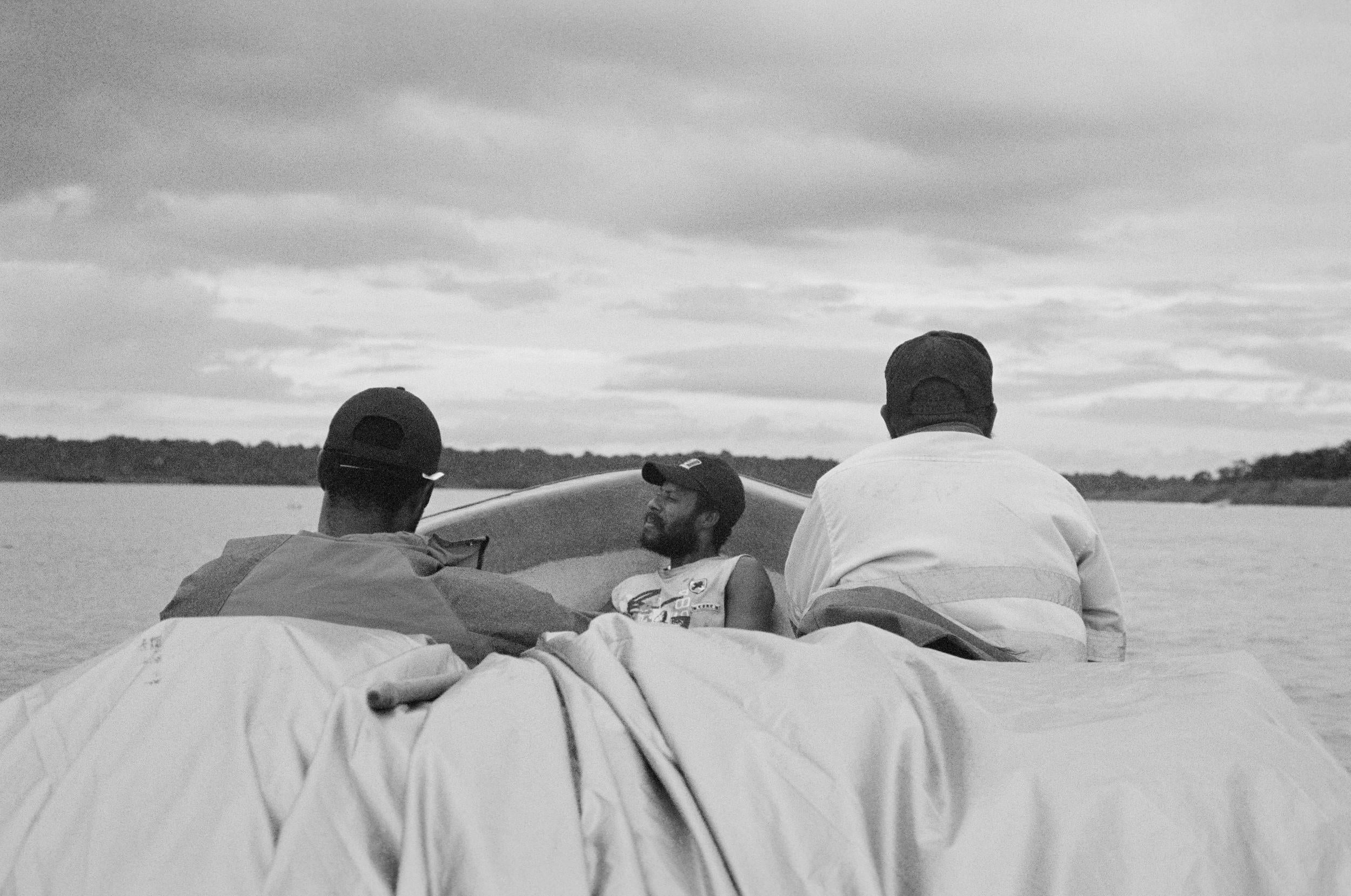 Volunteers sit towards the bow of the boat to counterbalance the weight of essential supplies