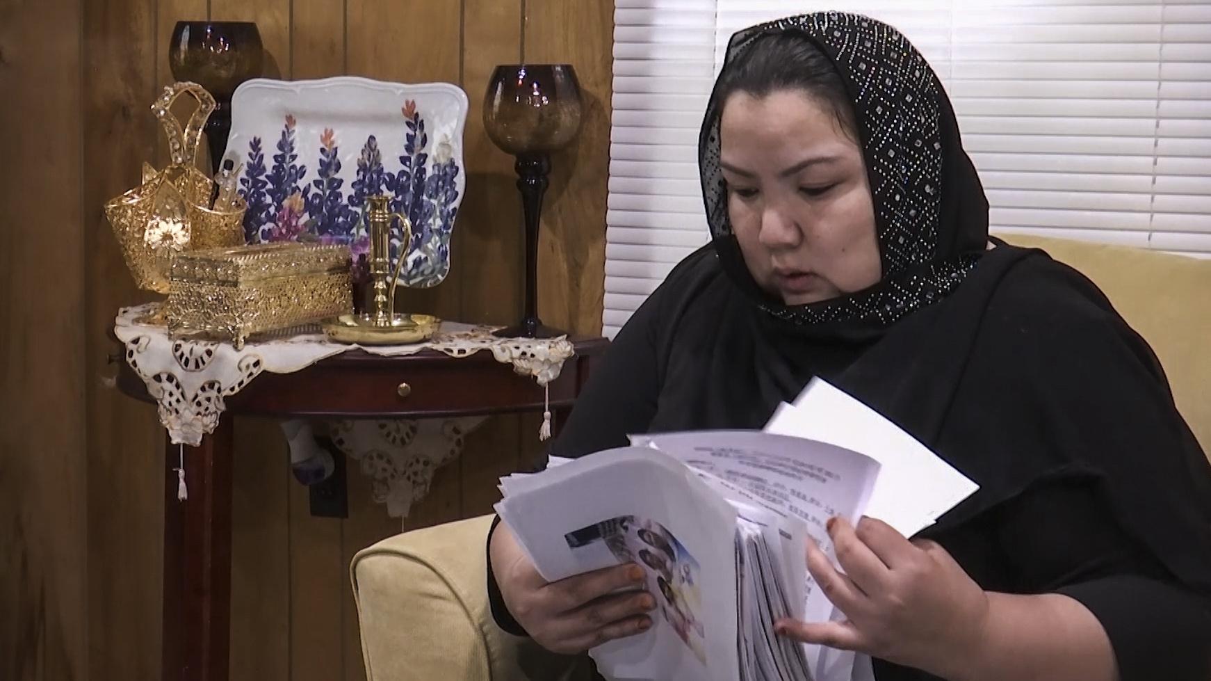 Zumret Dawut, a Uighur from China’s far western Xinjiang region, holds documents. Dawut says in China, she was forcibly sterilized for having a third child after being released from a detention camp