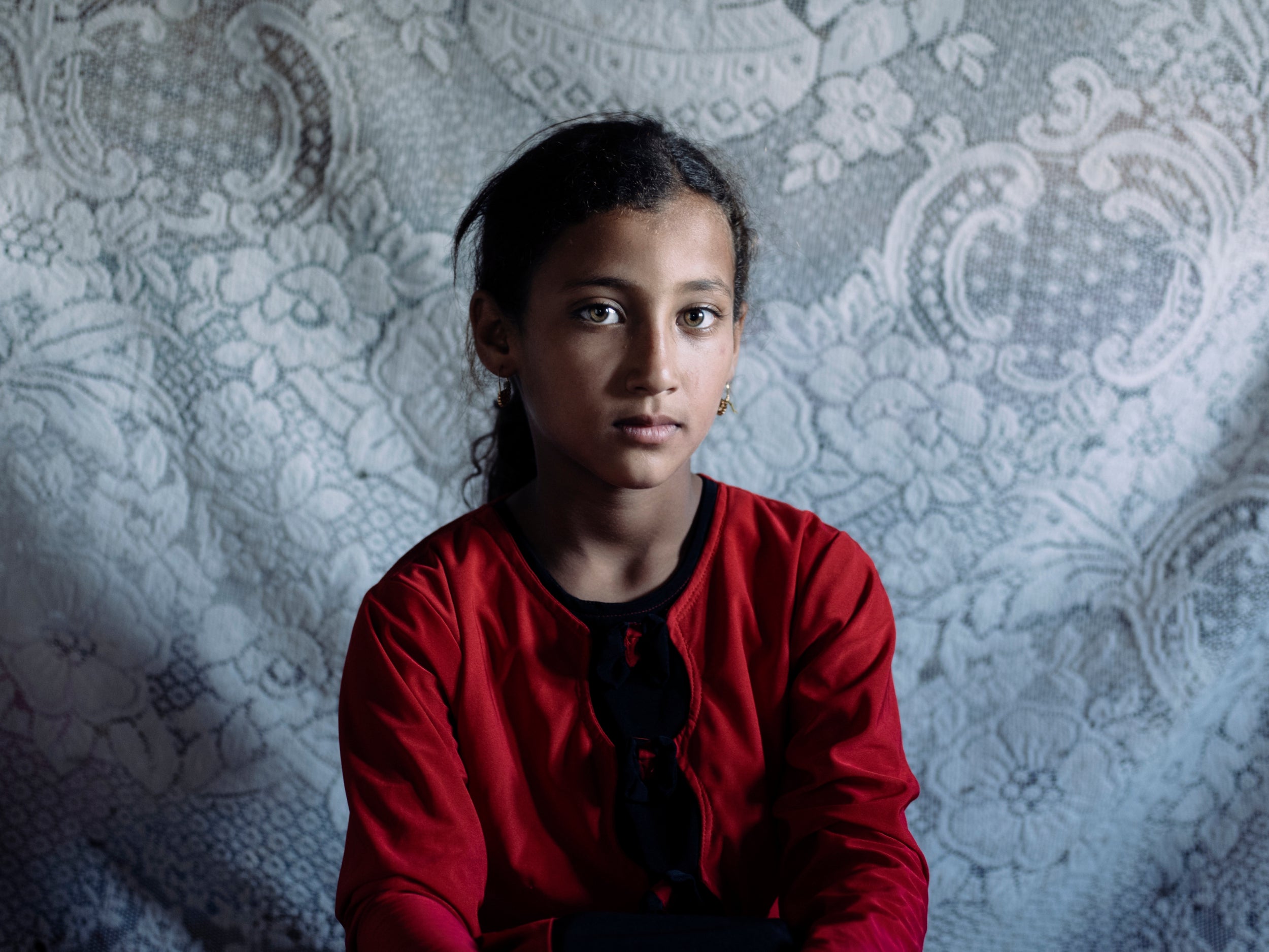 Moza, eight, has been caring for her mother in Mosul and started school two years late