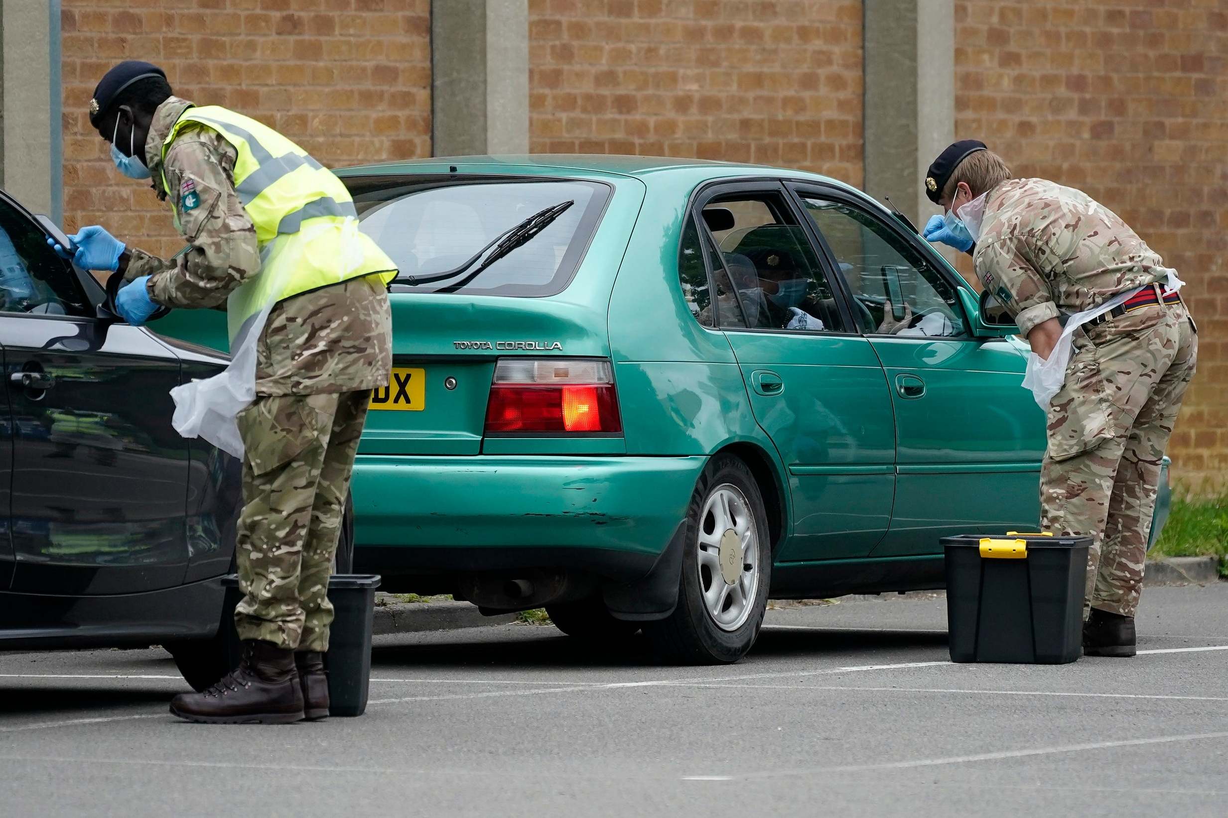 Soldiers from the royal logistics corp operate a mobile coronavirus testing site at Evington Leisure Centre on Monday in Leicester