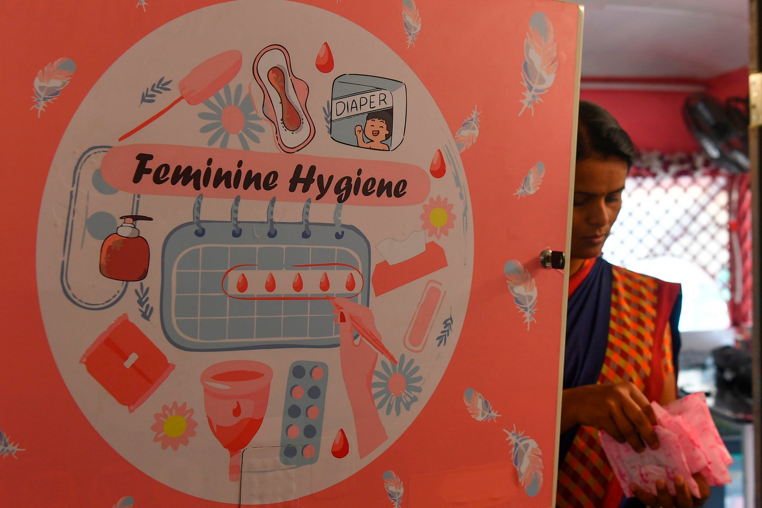 An attendant checks the stock of sanitary pads in a mobile toilet on a bus at a public park in Pune. (AFP/Getty)