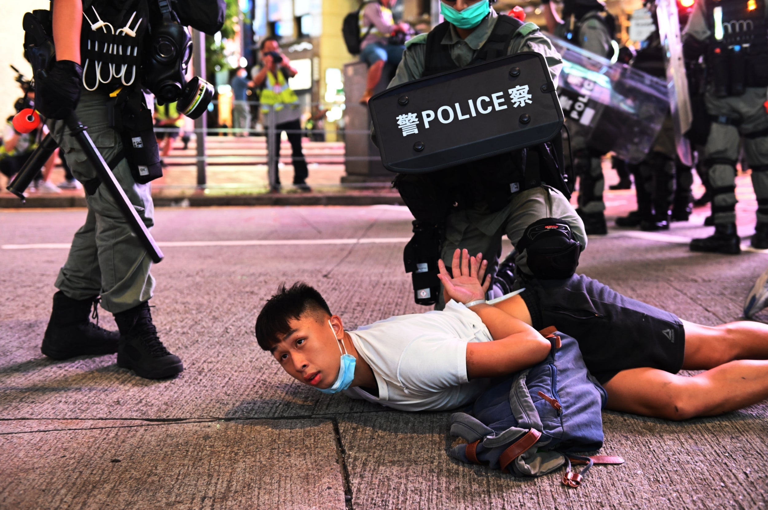 A demonstrator is detained by Hong Kong riot police after Beijing imposed the new national security law