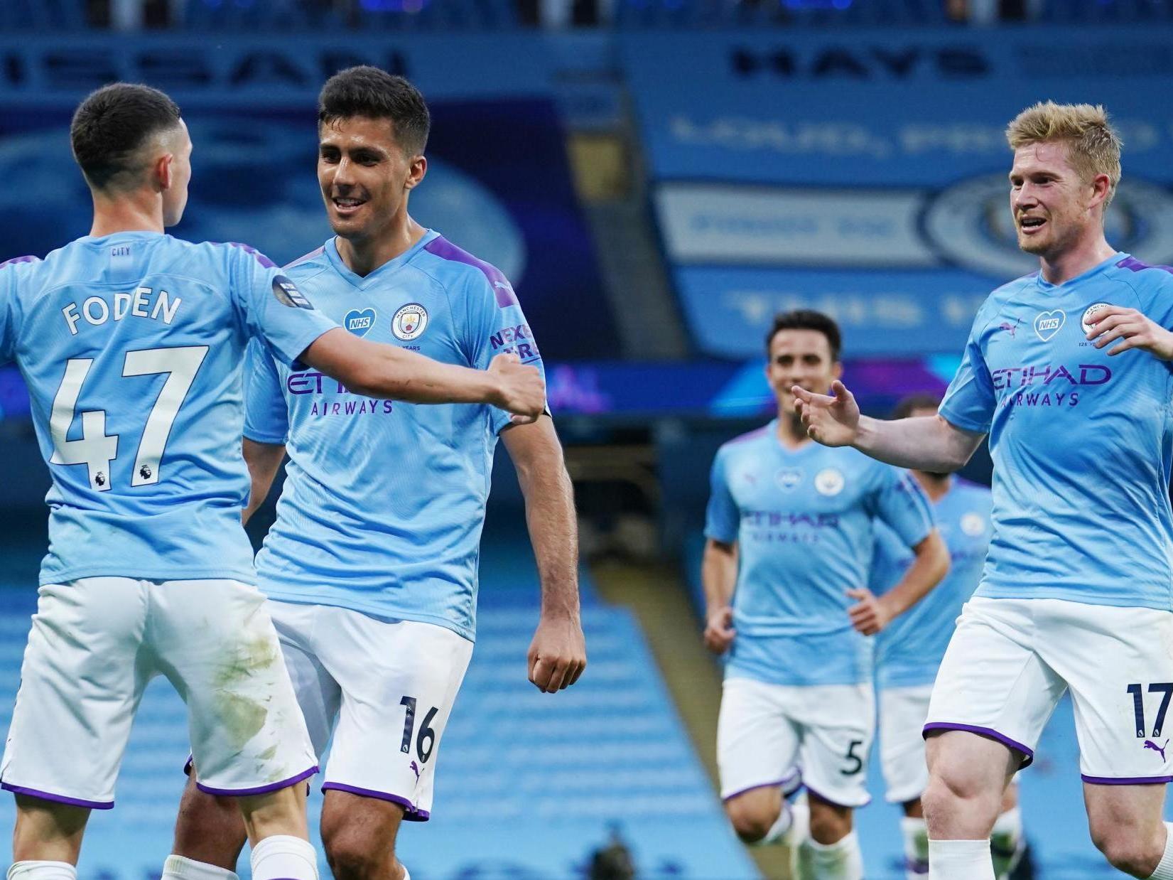 Phil Foden of Manchester City celebrates with Rodrigo and Kevin De Bruyne