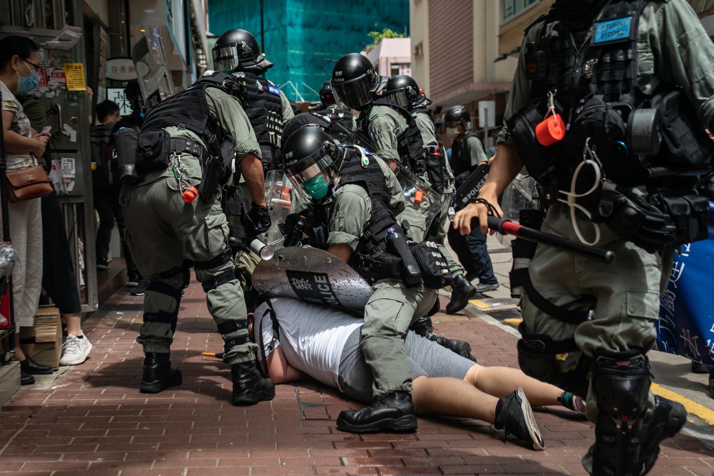 A man is detained by riot police during a demonstration against the new law (Getty Images)