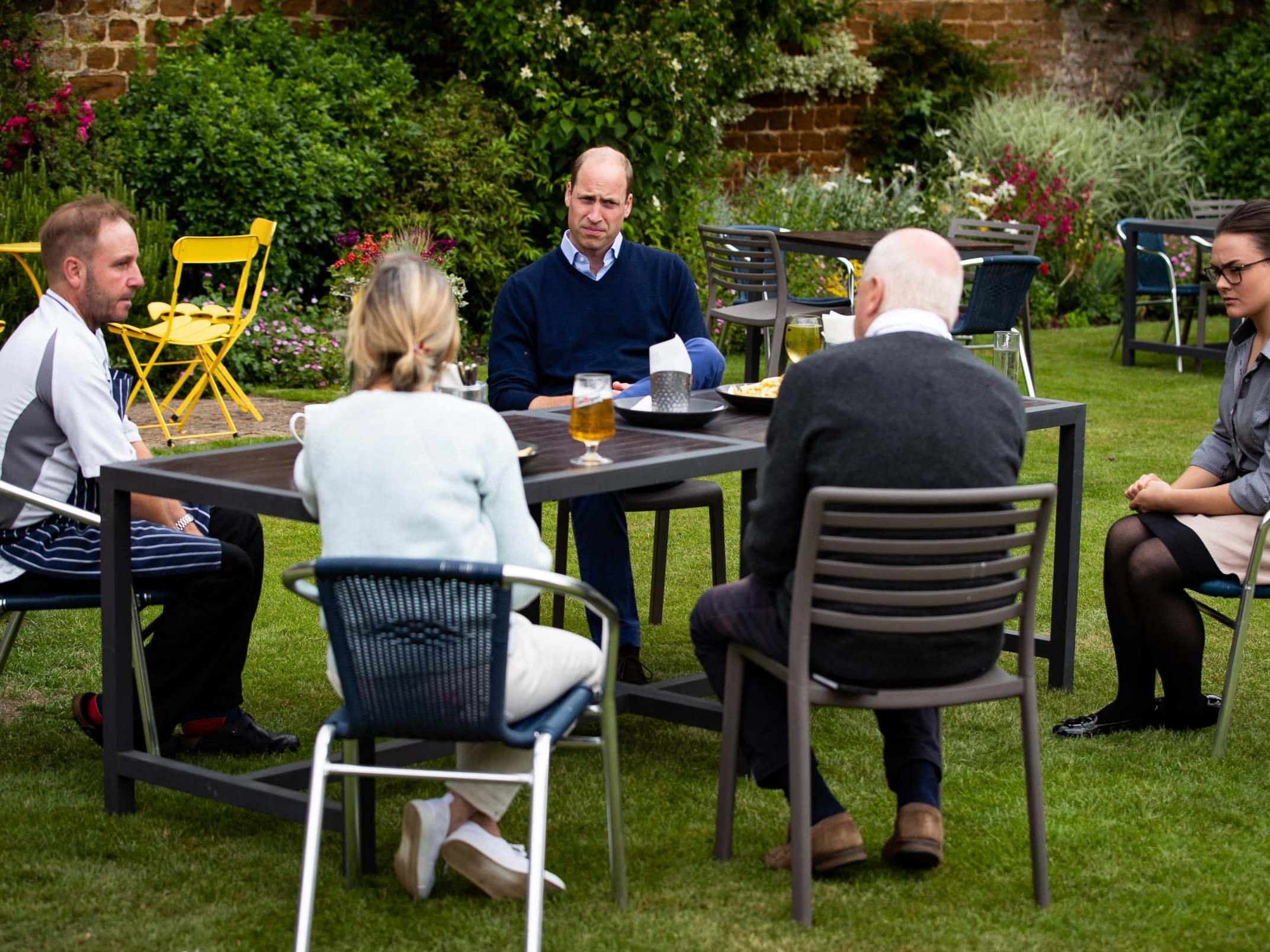 The Duke of Cambridge talks to the landlords and workers at The Rose and Crown pub in Snettisham, Norfolk.