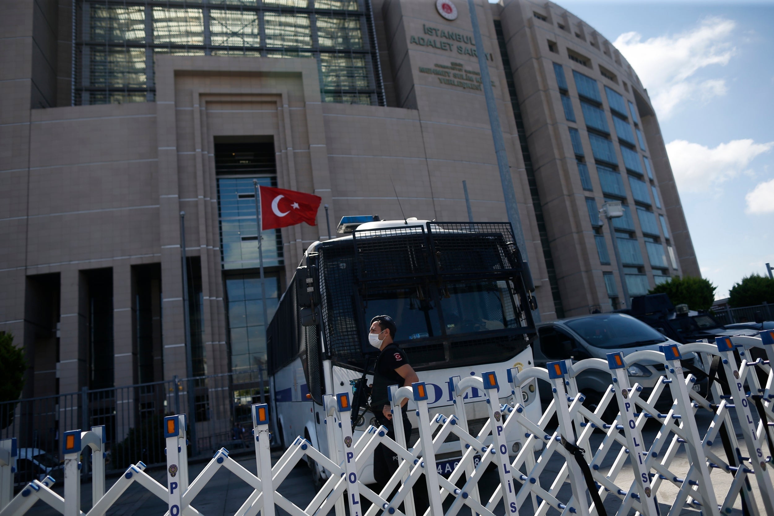 A police officer guards one of the entrances to the court in Istanbul