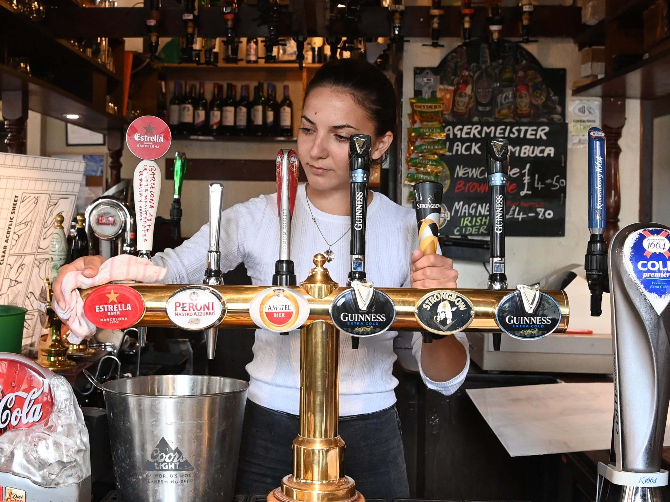 Pub staff get ready for reopening on "Super Saturday" in London's Soho district.