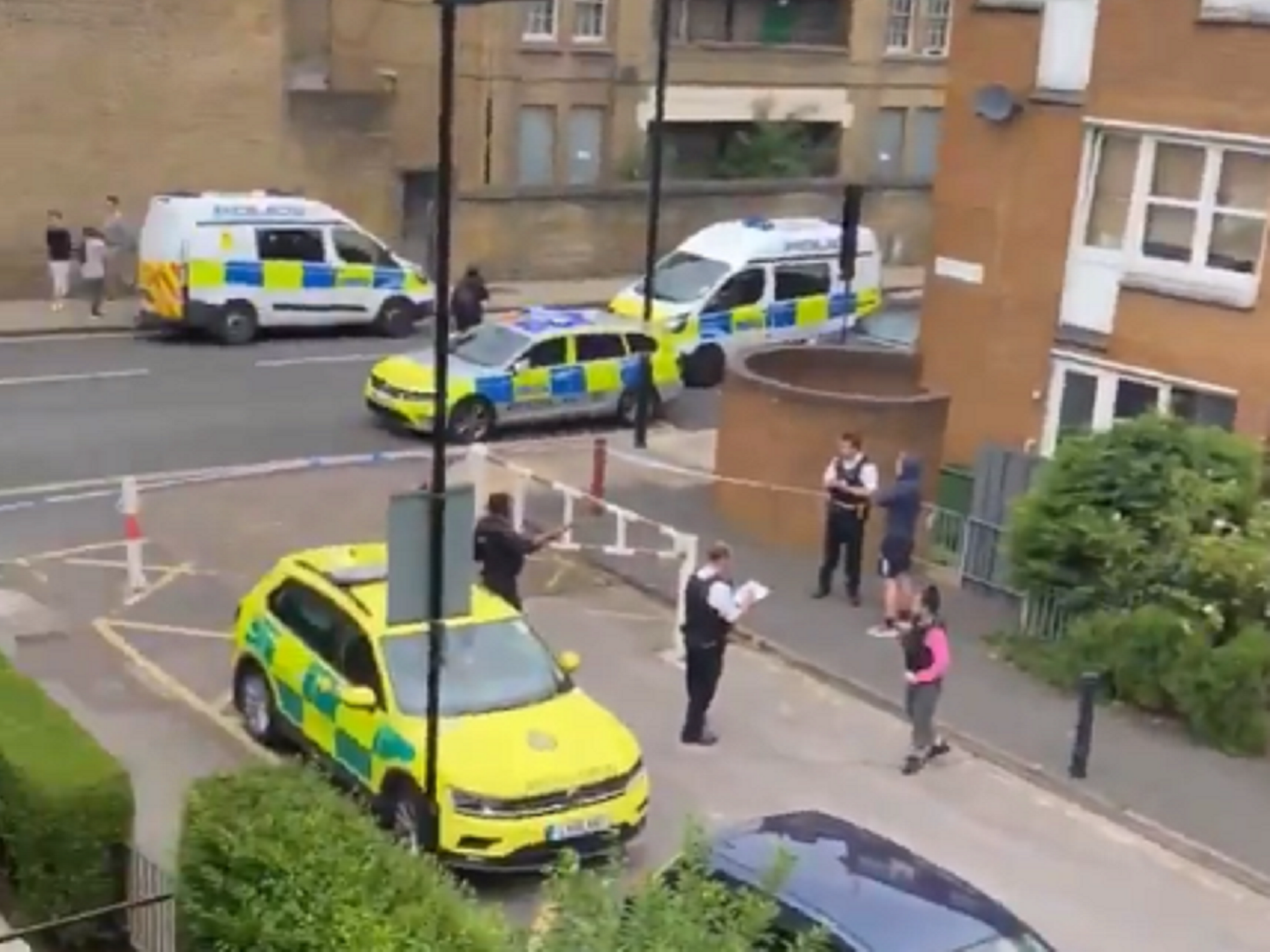 Police and paramedics at the scene of a fatal shooting in Islington, north London, where a man in his 20s died, 4 July 2020.