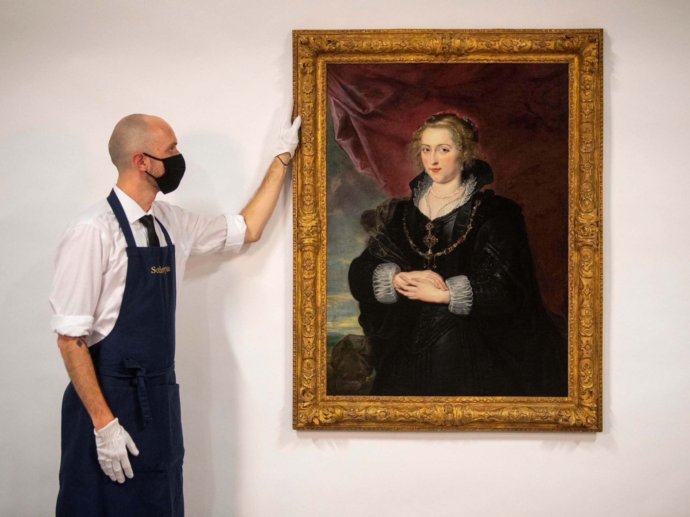 A Sotheby’s technician with the Rubens portrait, which was until recently hidden away in a private collection, unknown for much of the 20th century