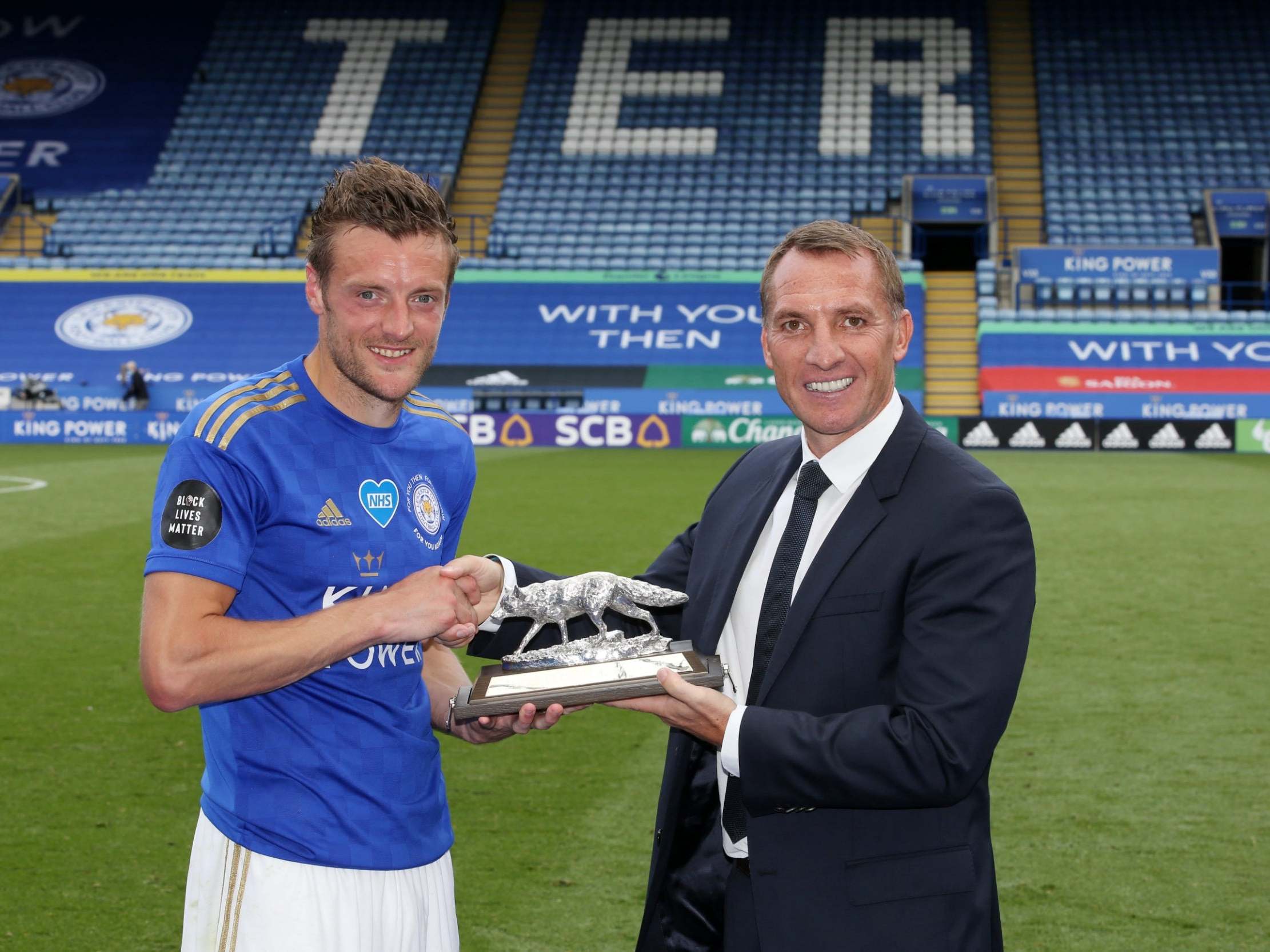 Jamie Vardy receives an award after scoring his 100th Premier League goal (Getty)