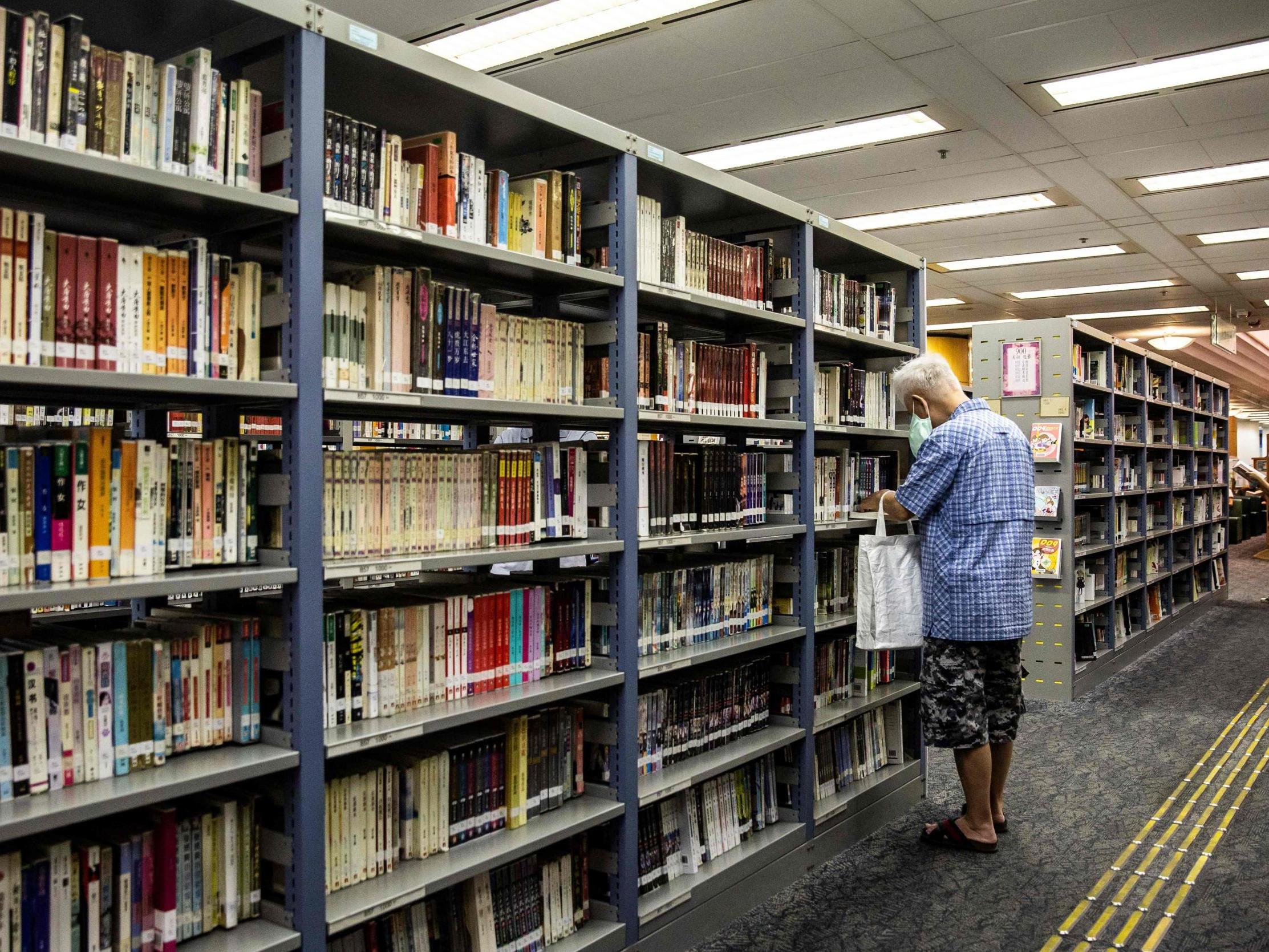 A man looks through the shelves of a public library in Hong Kong on 4 July, 2020.