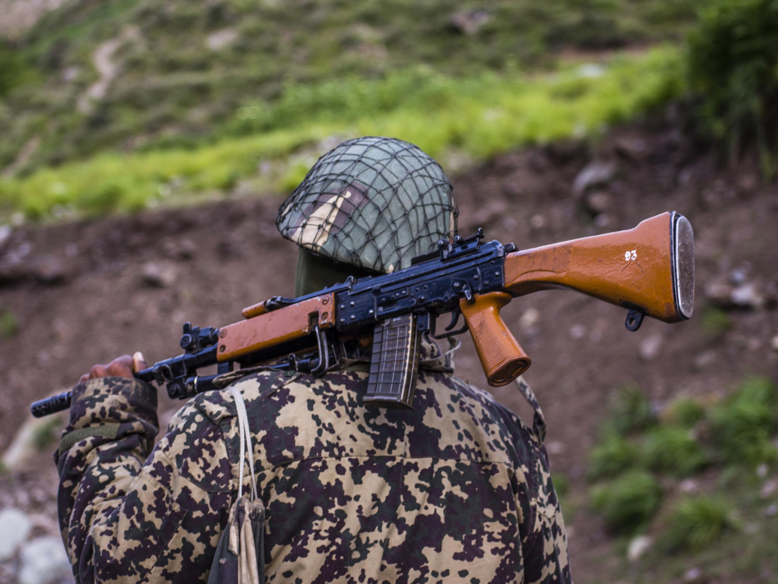 An Indian Border Security Force (BSF) soldier guards a highway along the border with China