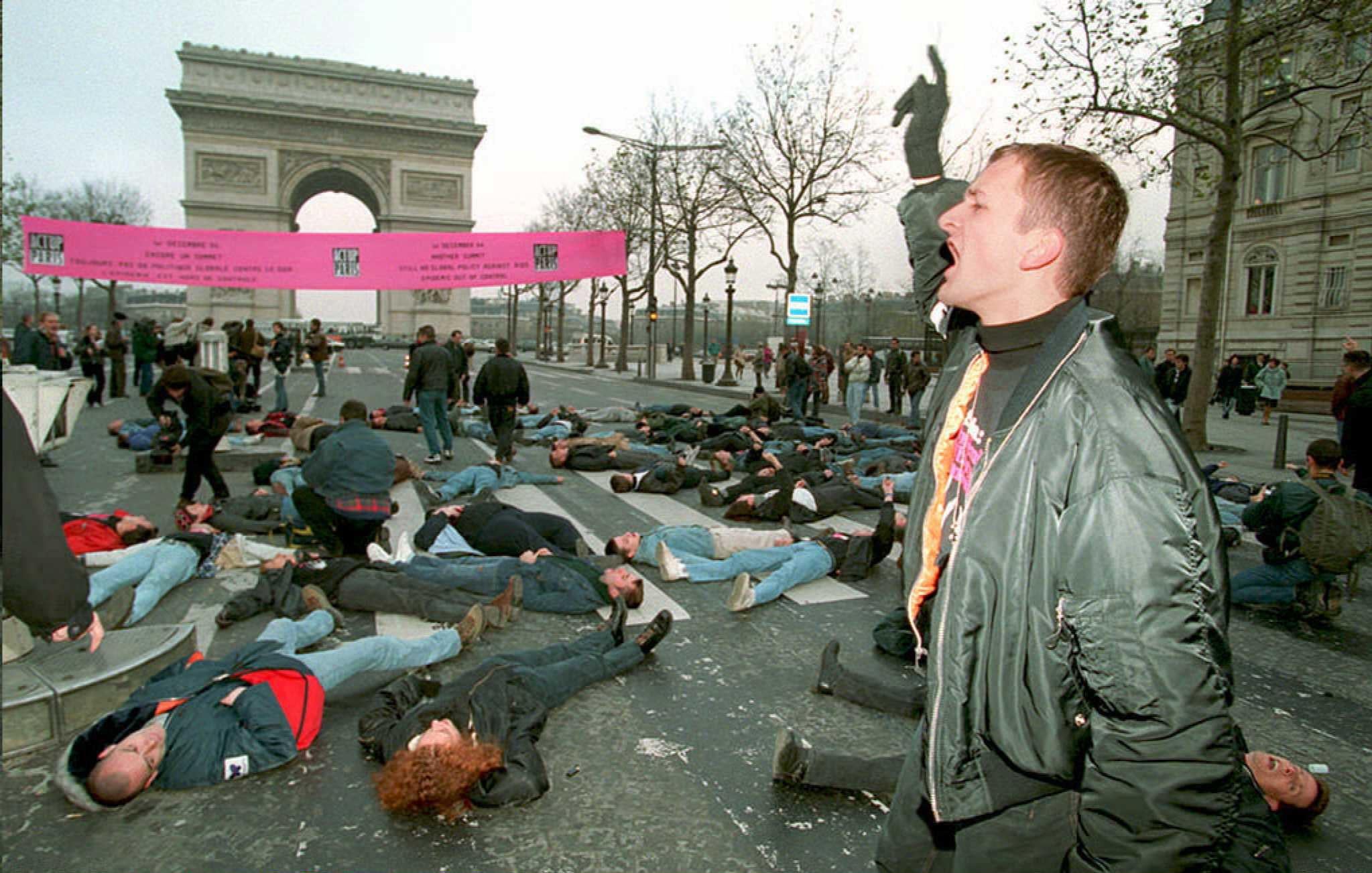 Members of the activist group ACT UP lie on the Champs-Elysees during the 1994 Aids summit in Paris