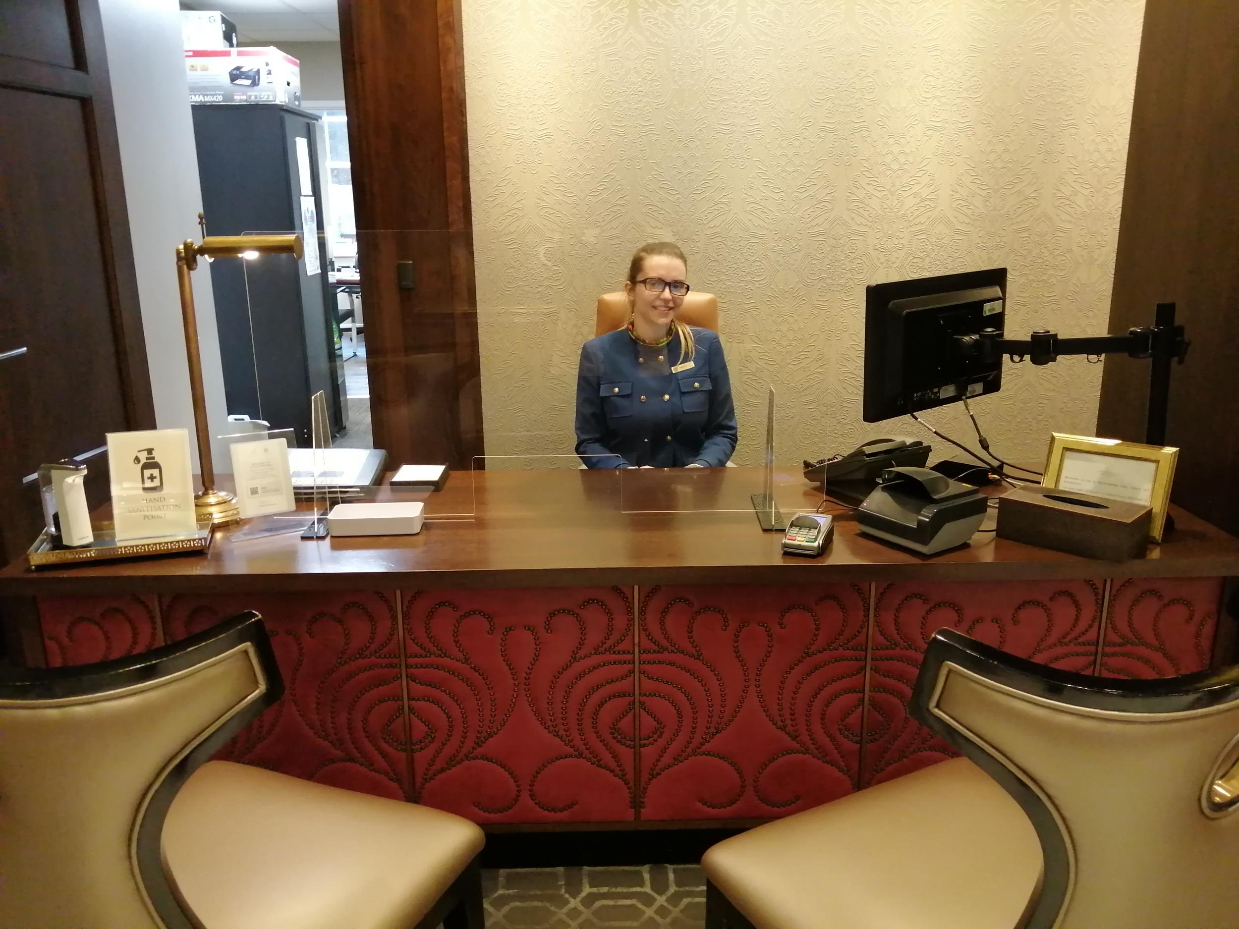 Reception desks have plastic screens