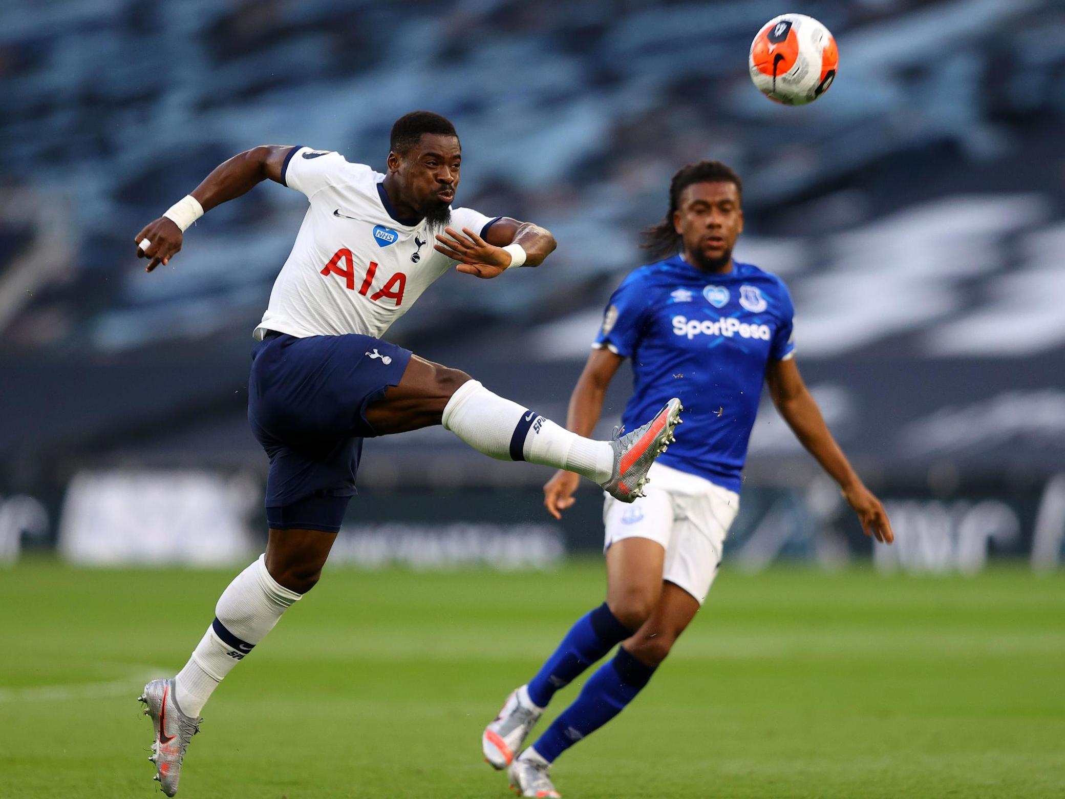 Aurier thumps the ball clear with Iwobi closing in