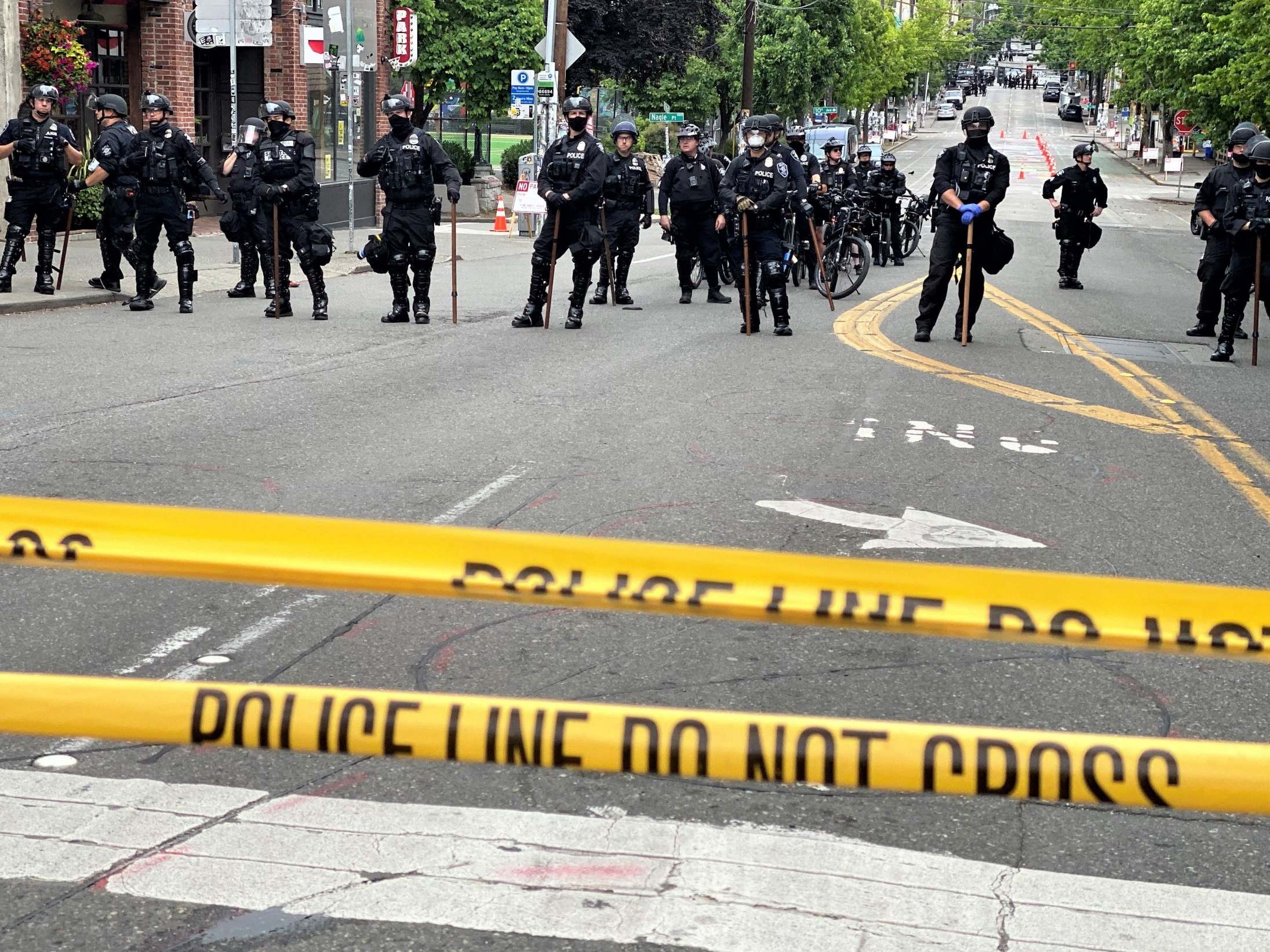 Police officers work to clear Seattle’s CHOP