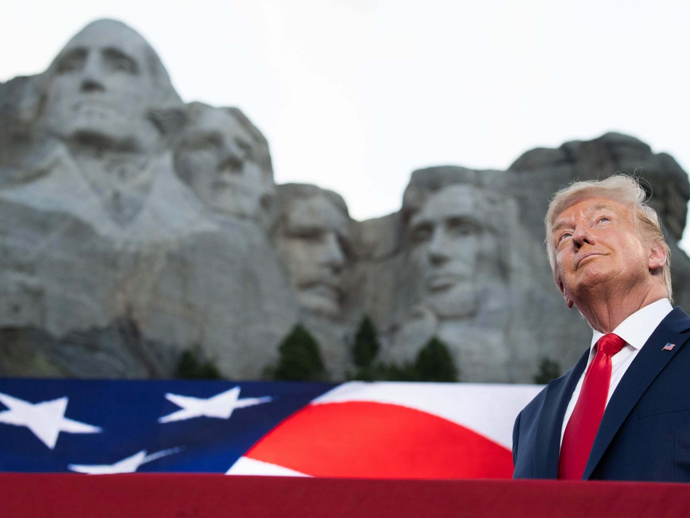 Donald Trump stands in front of Mount Rushmore