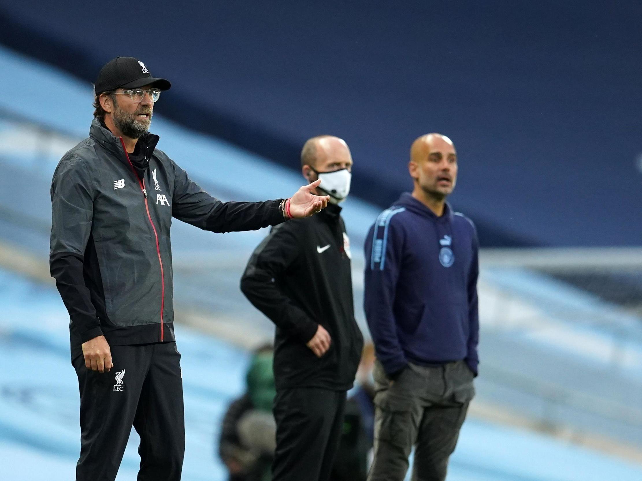 Klopp and Guardiola watch on from the touchline