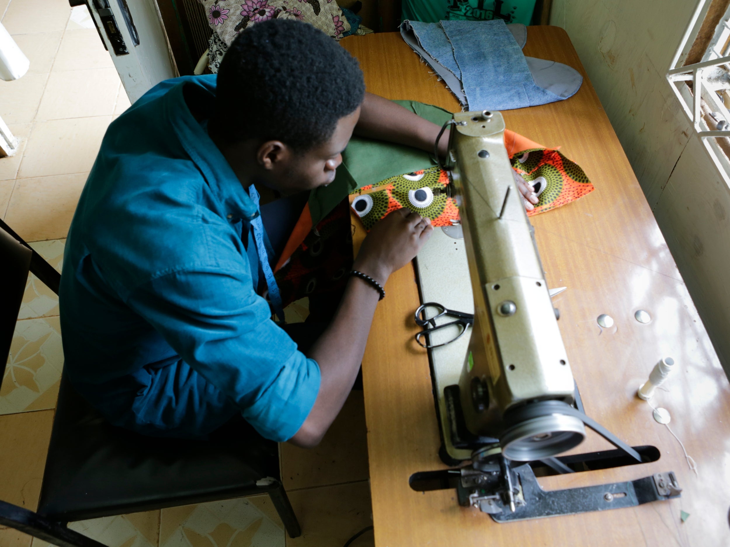 Upcoming Kenyan fashion designer Moses Omondi Odhiambo at work