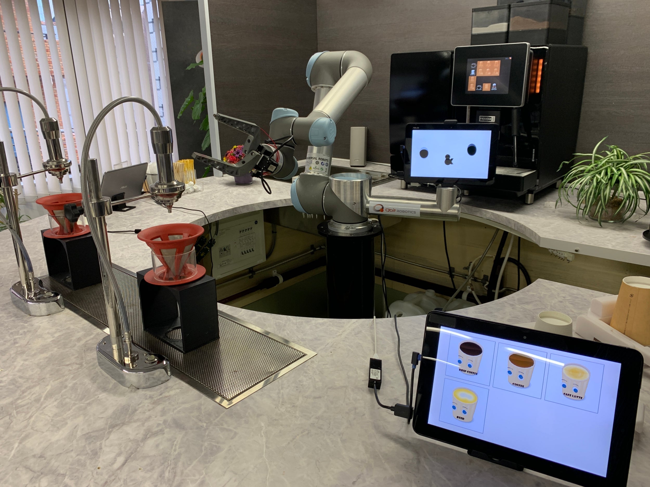 A robotic bartender makes coffee and mixes drinks at the offices of Qbit Robotics in Tokyo