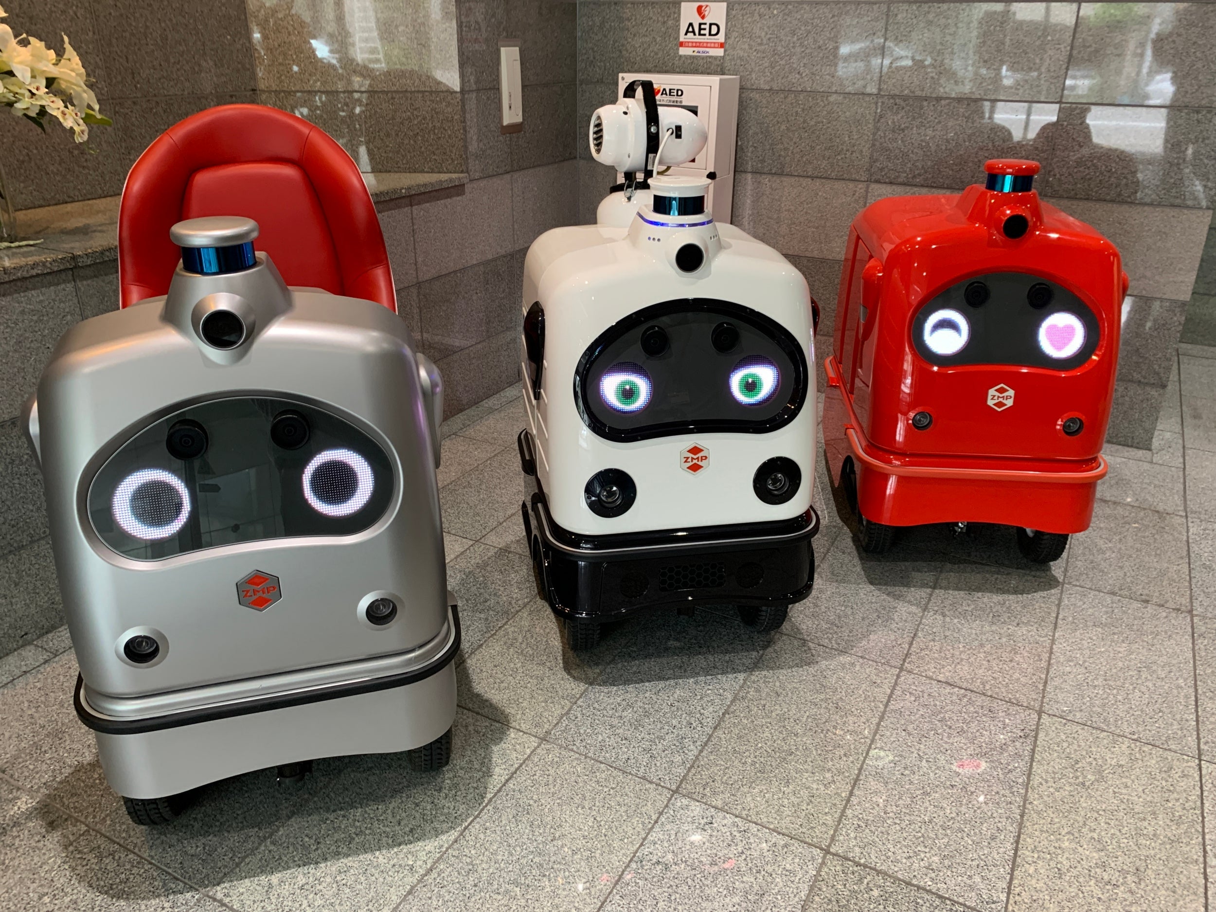 Three robots developed by ZMP are seen in the company’s office lobby in Tokyo