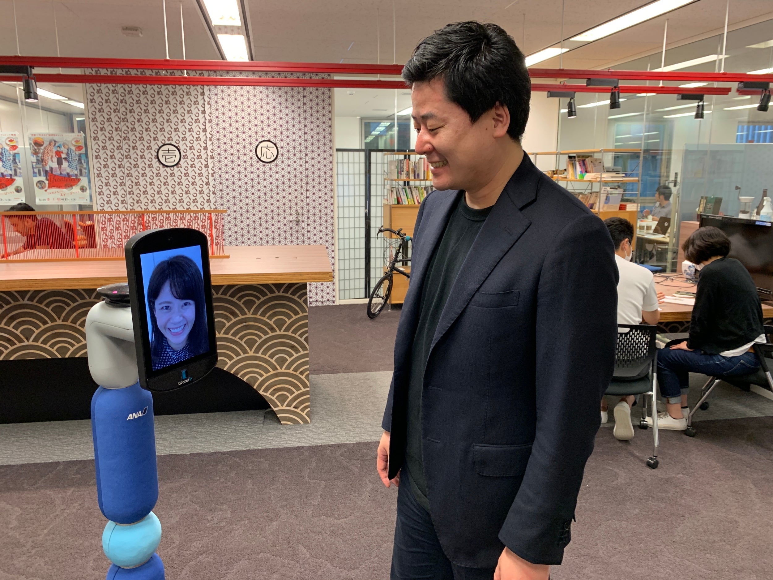 Akira Fukabori demonstrates his company's Newme robot avatar