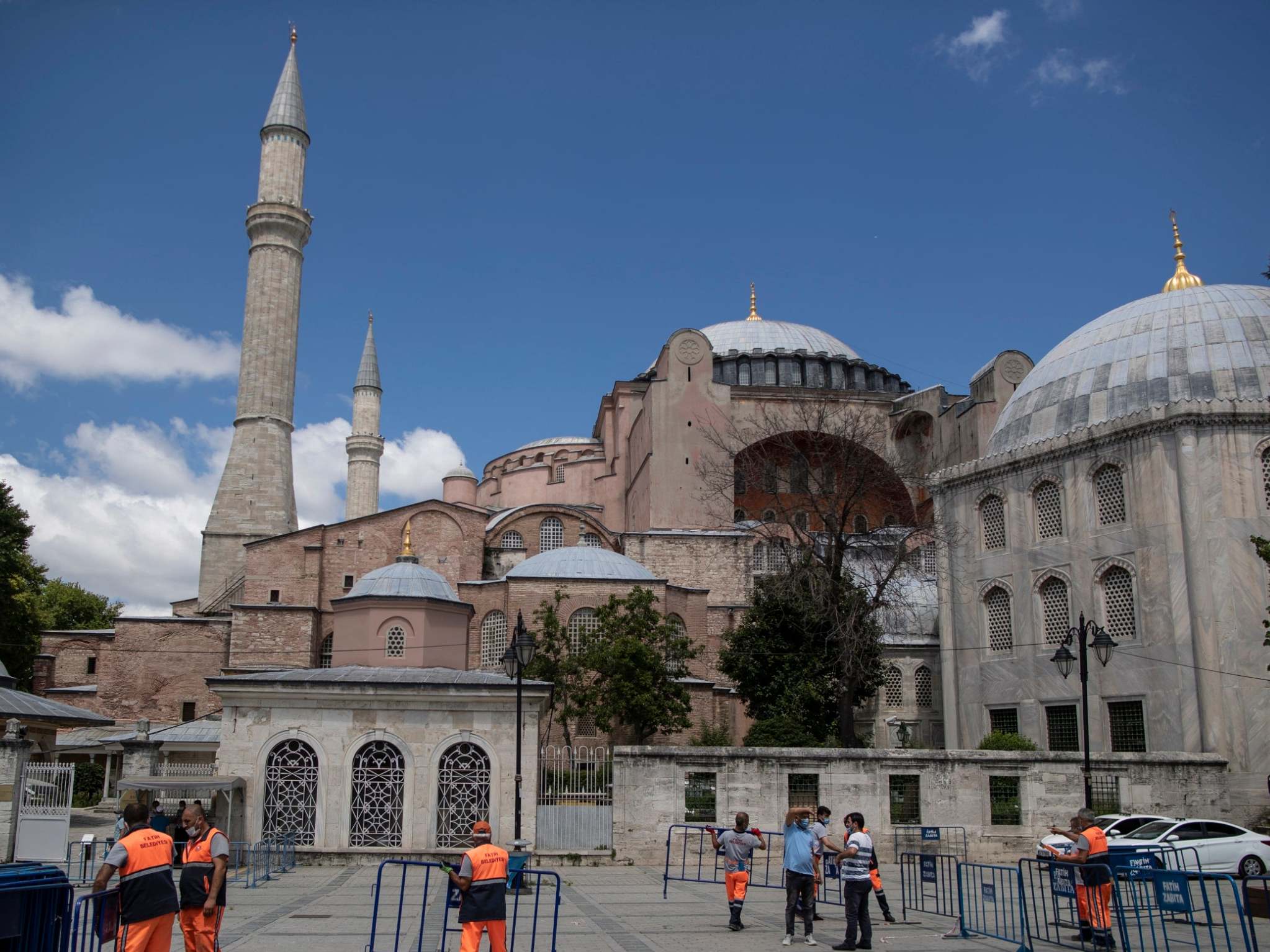 Fatih municipality personnel place a safety barrier in front of the Hagia Sophia museum in Istanbul