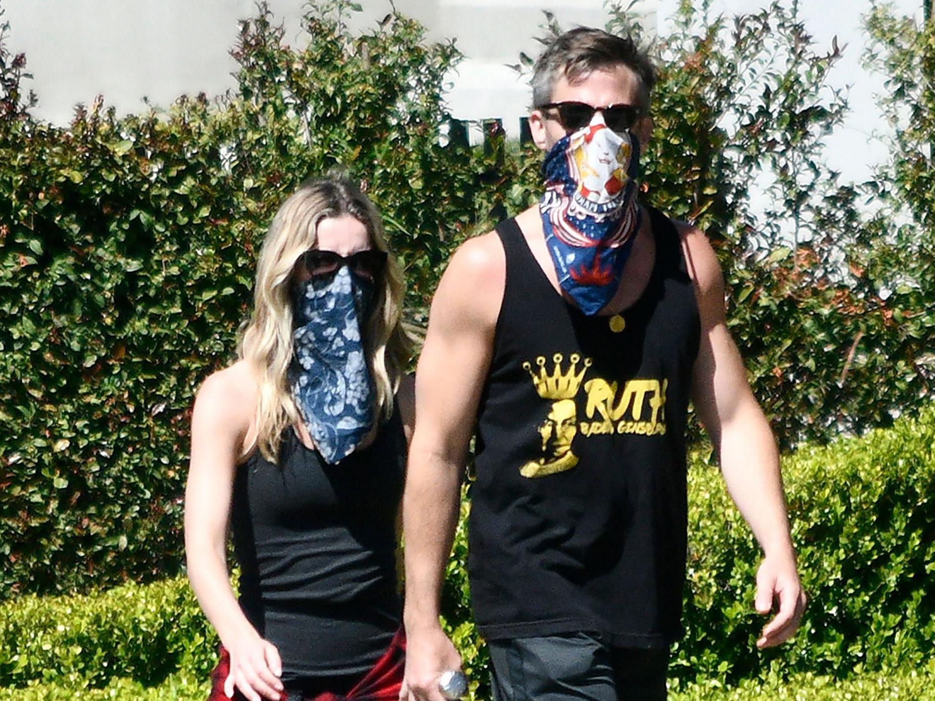 Annabelle Wallis and Chris Pine wear bandanas while on a walk.