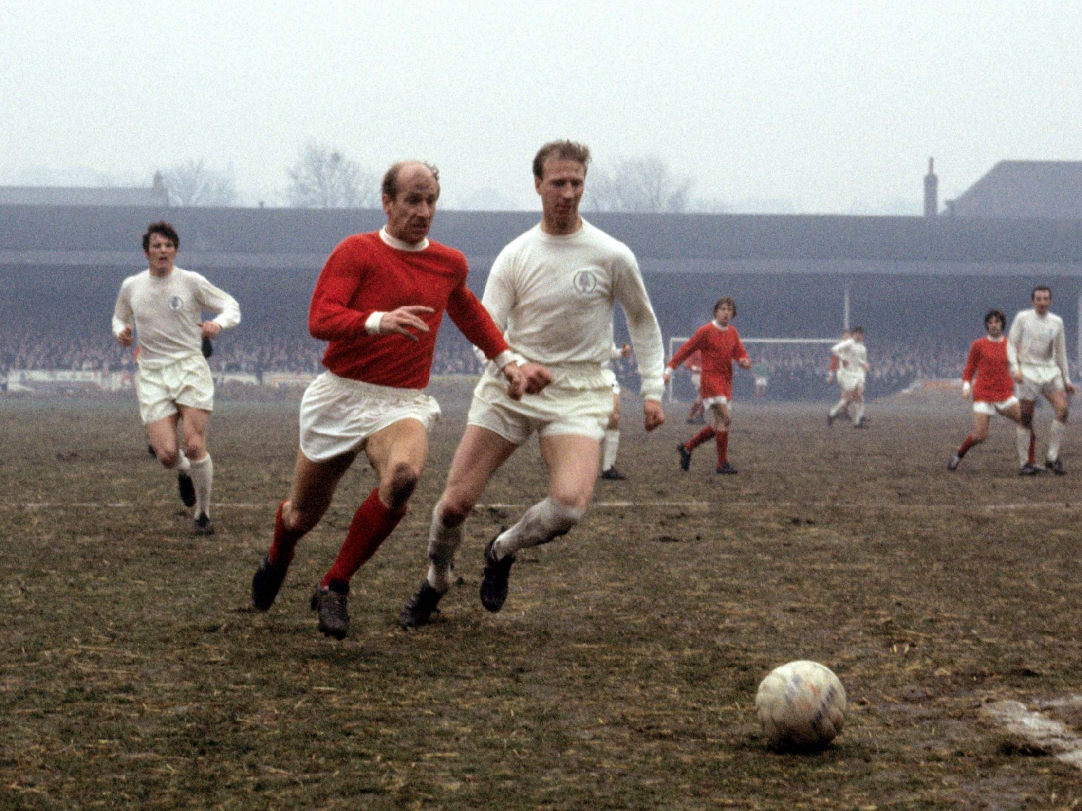 Bobby Charlton (left) takes on older brother Jack Charlton in a game between Manchester United and Leeds