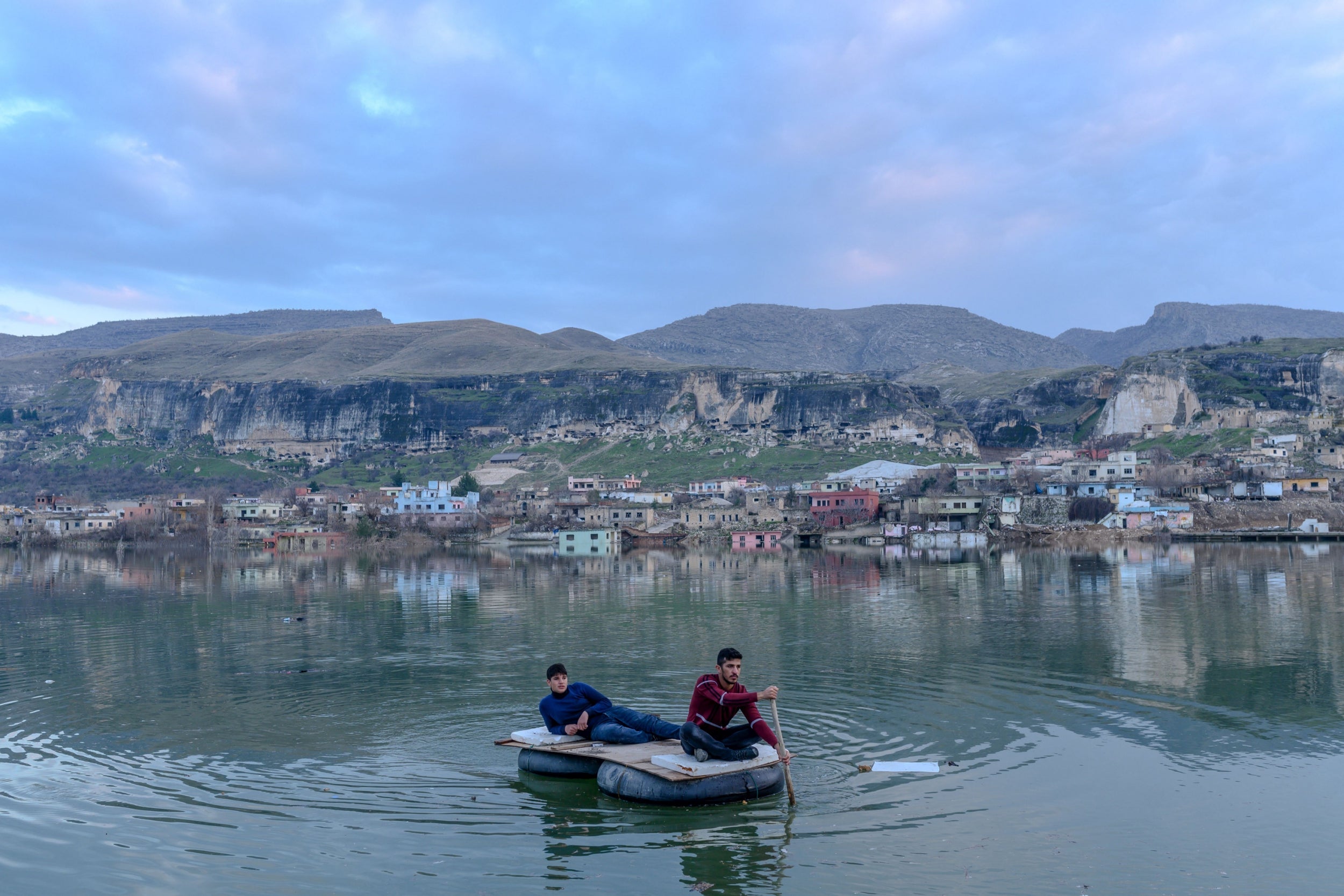 Kurdish youths visit abandoned houses in Hasankeyf befo