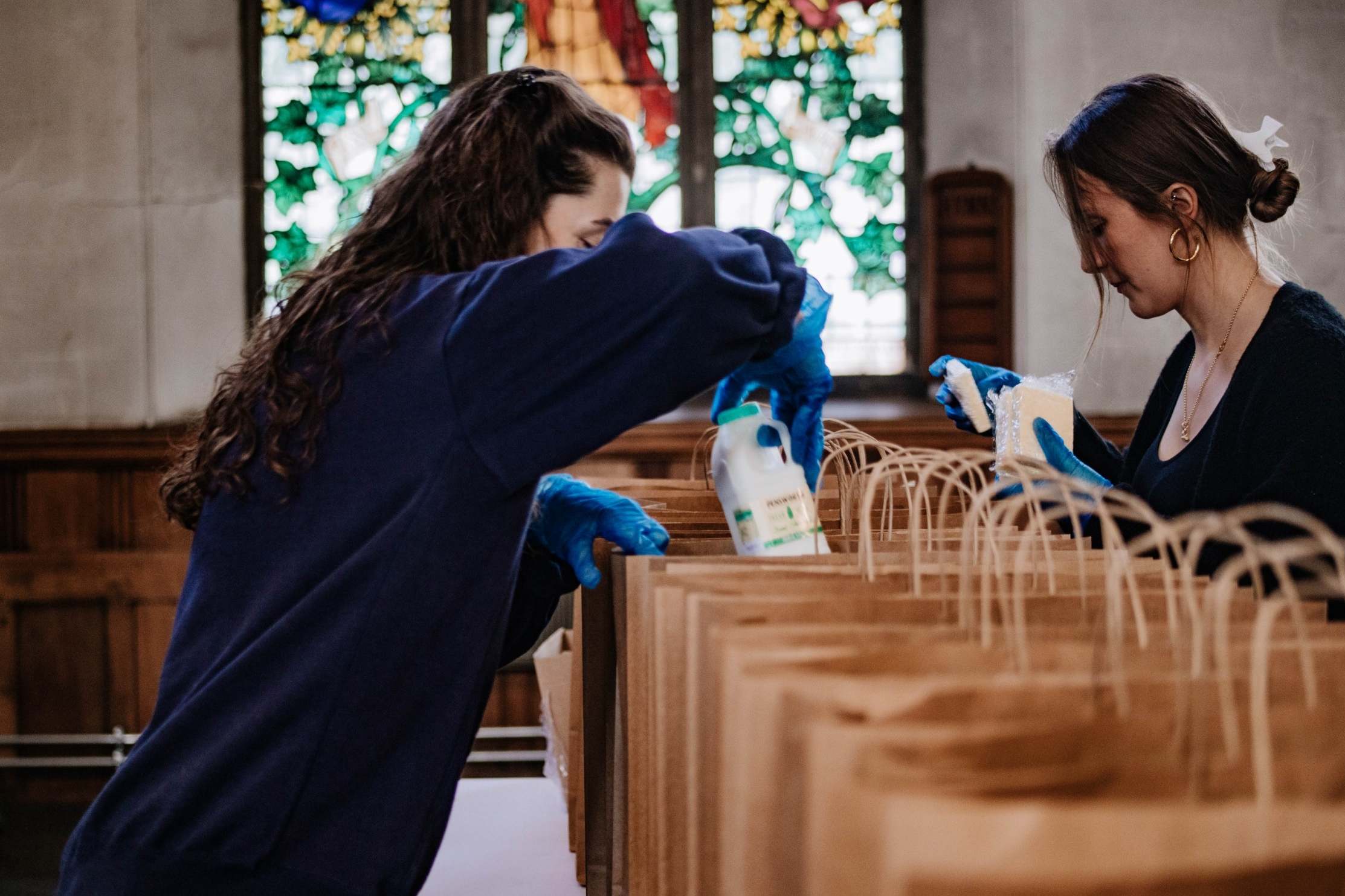 Volunteers from the Love Your Neighbour network pack emergency food and supplies bags