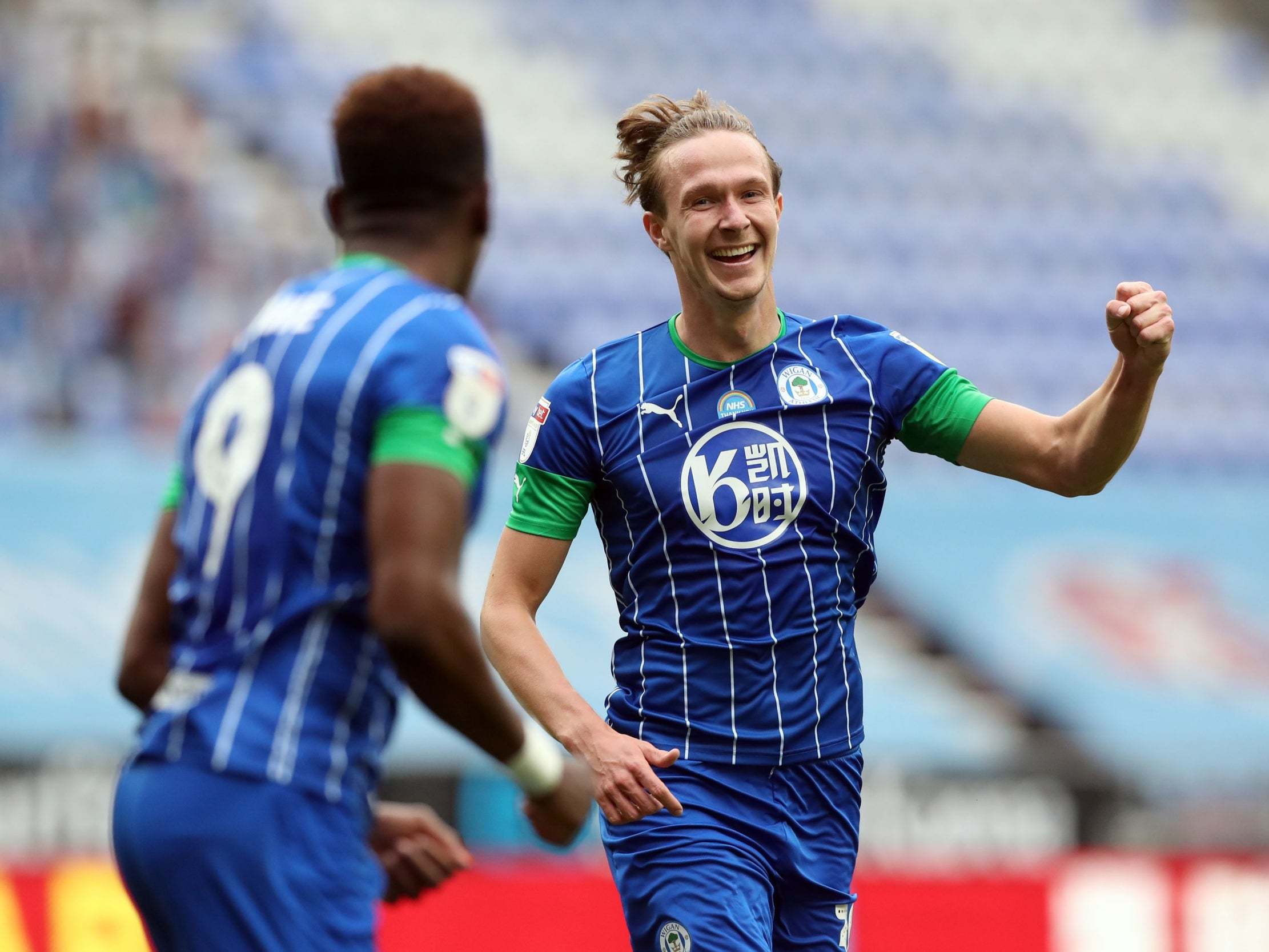 Kieran Dowell celebrates scoring Wigan's sixth goal