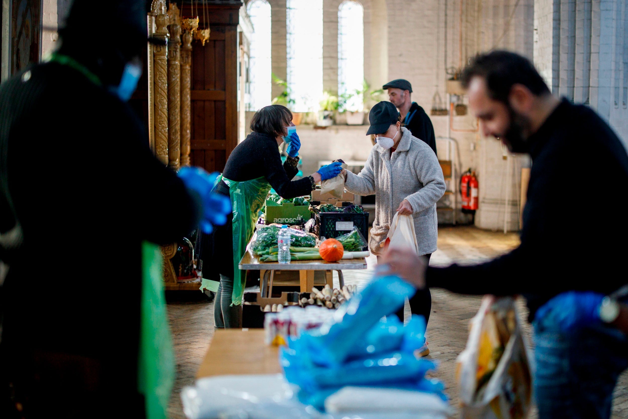 Volunteers hand out food in Leytonstone, east London, to vulnerable members of the community