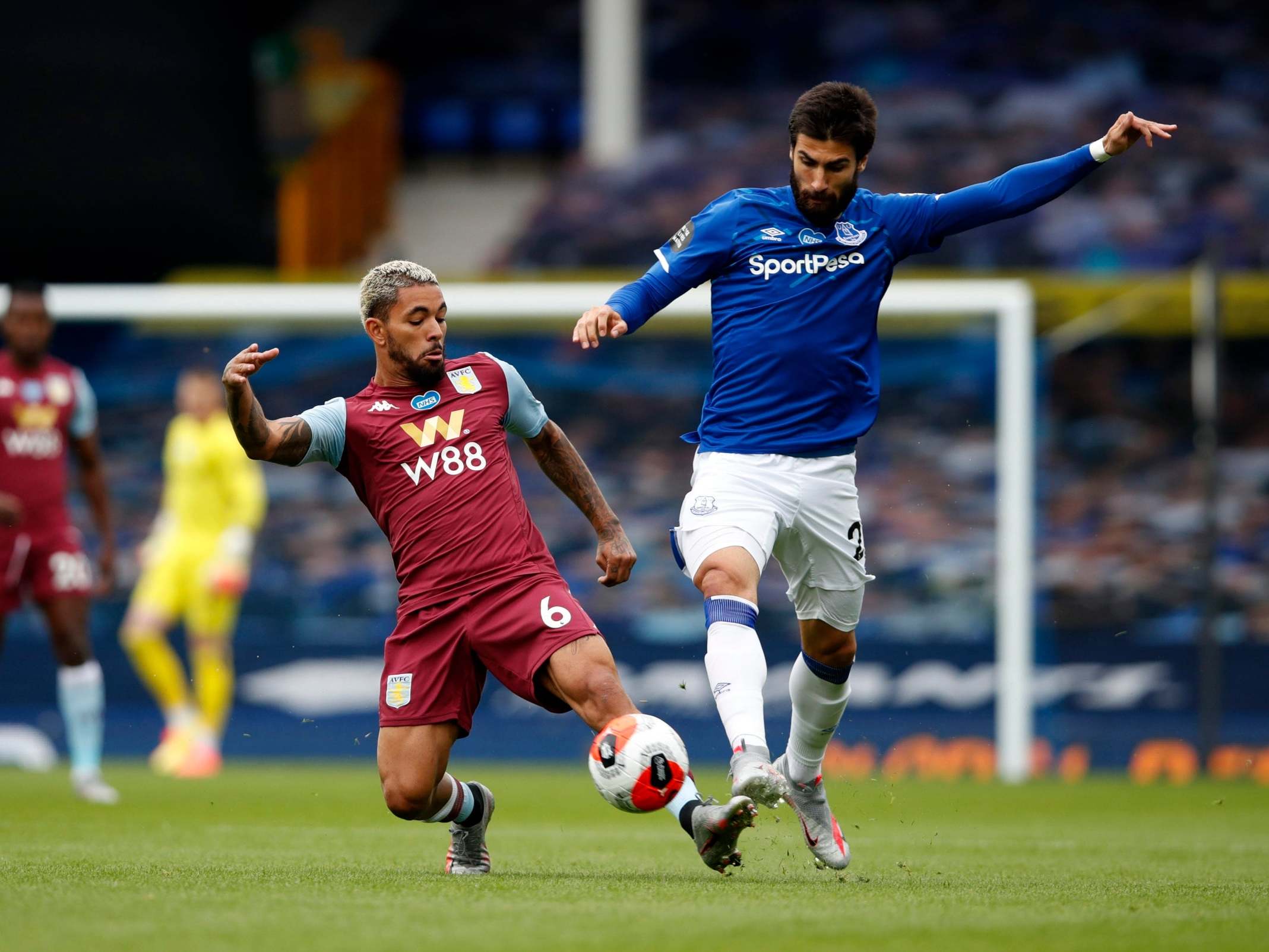 Douglas Luiz of Aston Villa tackles Andre Gomes